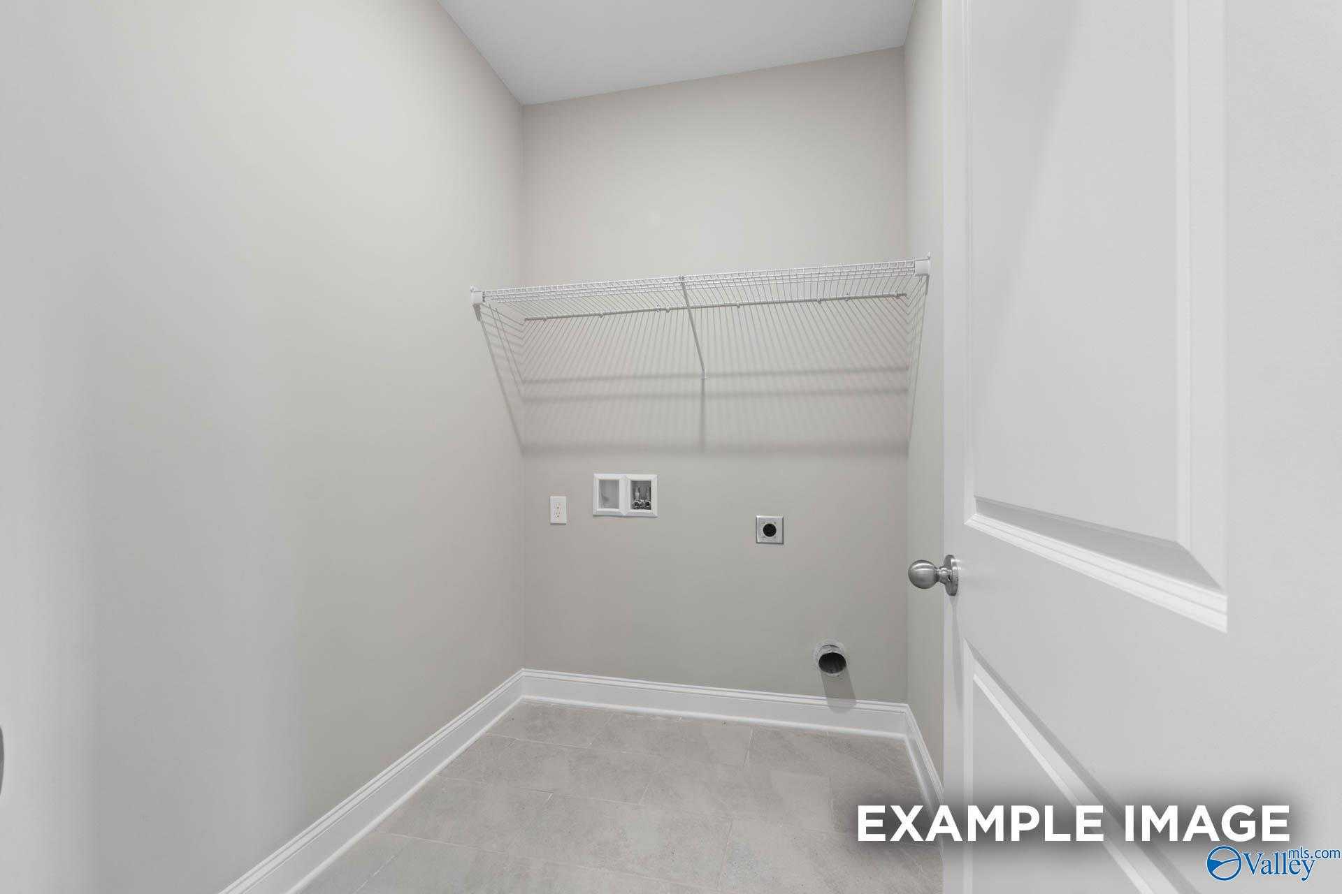 Modern laundry room with wire shelving, washer/dryer hookups in Davidson Homes The Montgomery B, Hartselle, Alabama