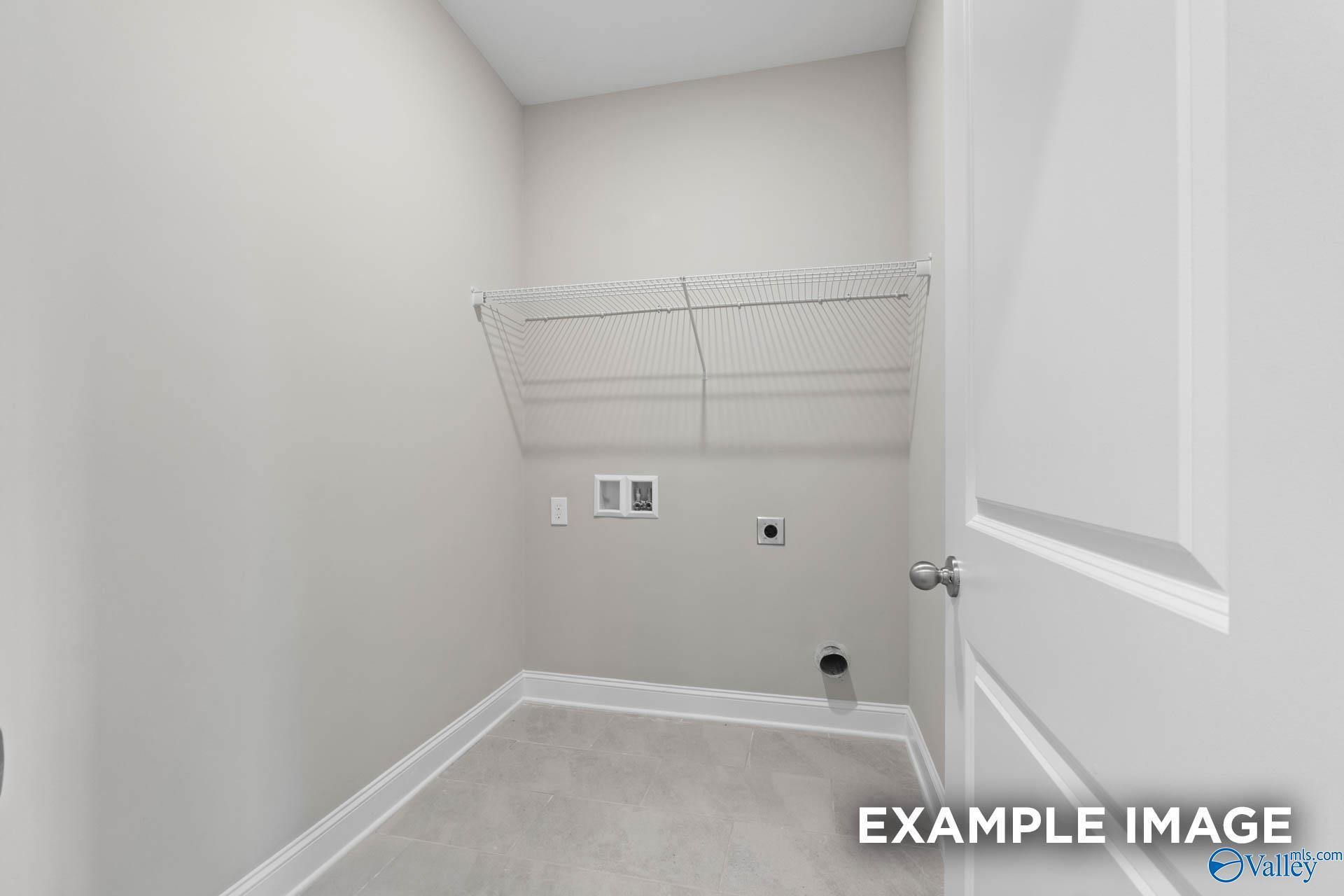 Spacious laundry room with wire shelving and washer/dryer hookups in Davidson Homes The Montgomery B, Hartselle, Alabama