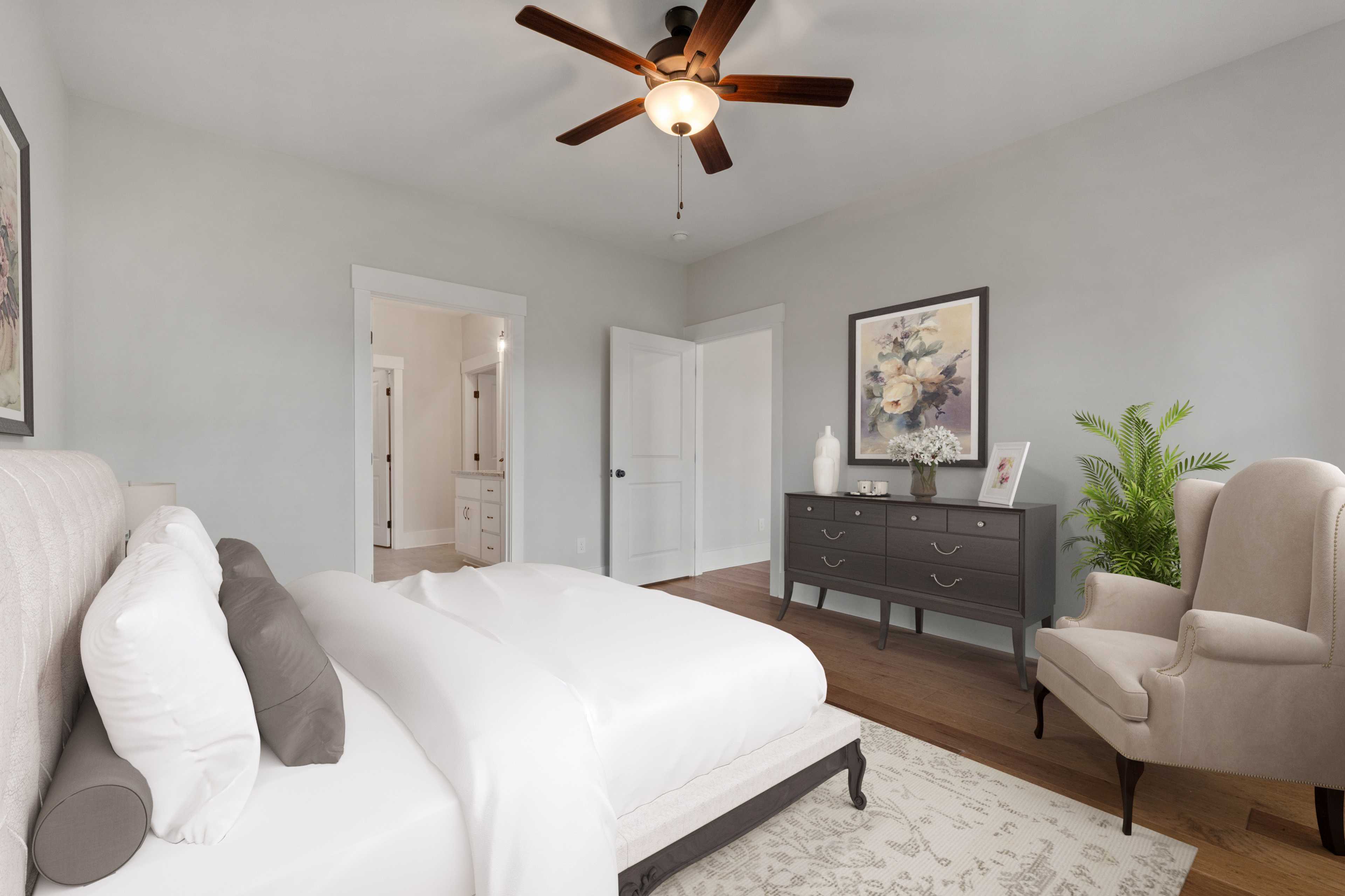 Spacious master bedroom at The Villas at Barnett's Crossing in Madison AL with king bed, ceiling fan, and en-suite bath