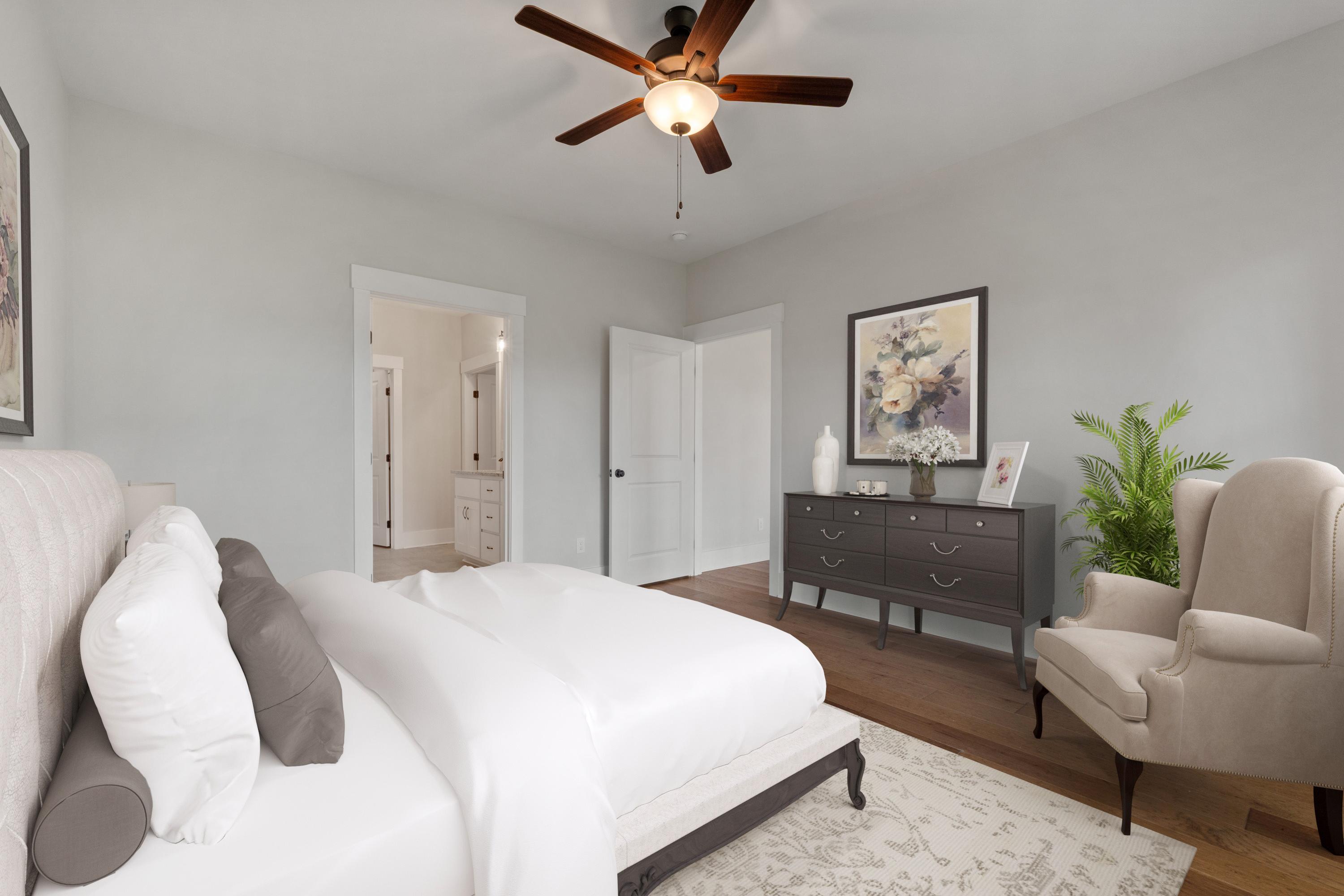 Spacious master bedroom at The Villas at Barnett's Crossing in Madison AL with king bed, ceiling fan, and en-suite bath