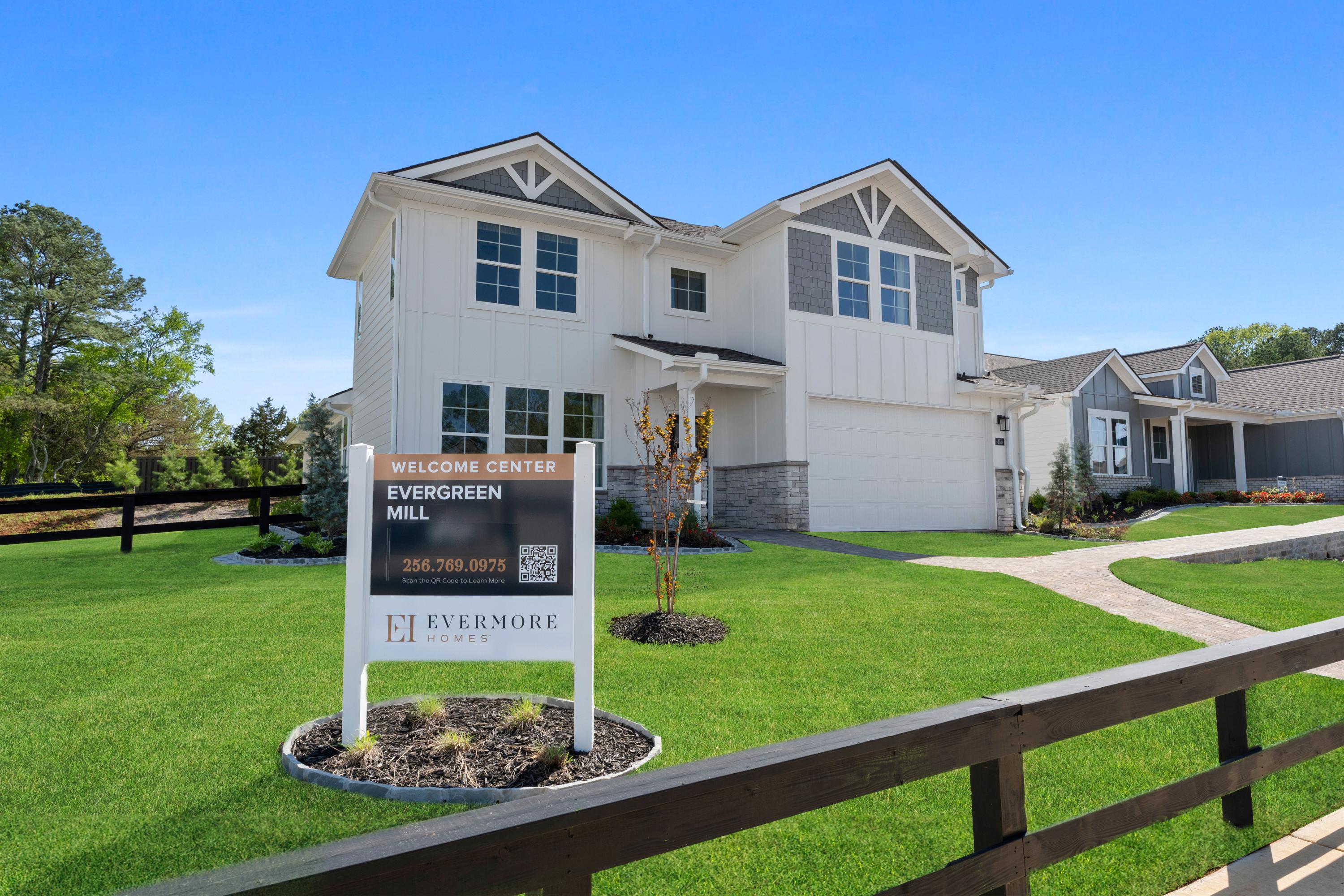 Modern Evergreen Mill welcome center home in Madison, Alabama by Evermore Homes with sign, gabled roof, and landscaped yard