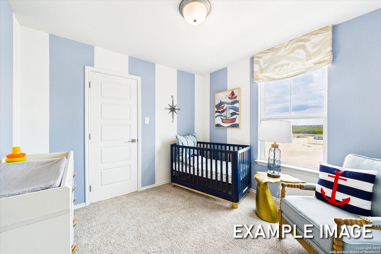 Nautical nursery with blue-white striped walls, wooden crib, changing table, and armchair in Davidson Homes The Brazos C, San Antonio