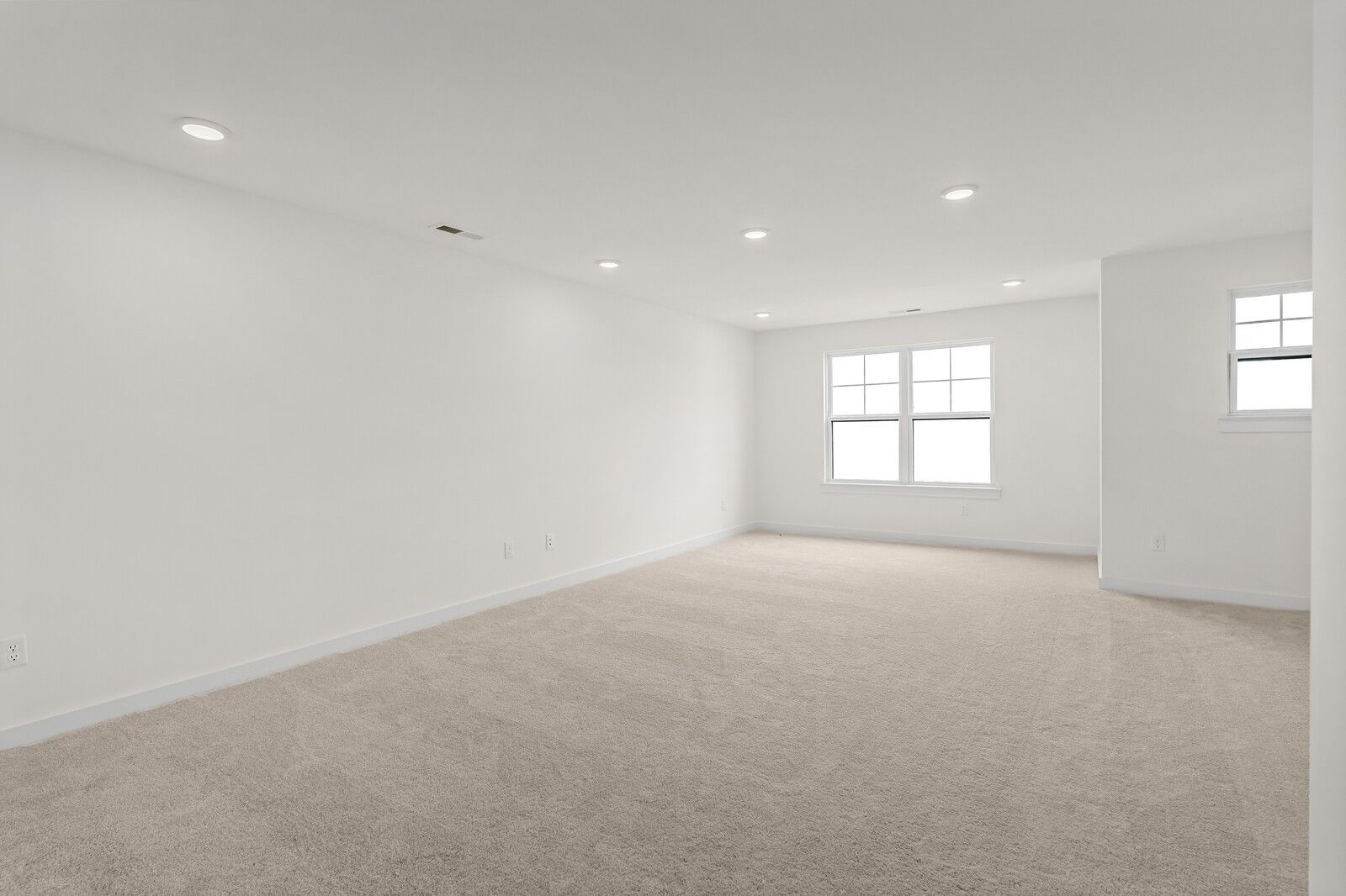 Empty bedroom featuring beige carpet, white walls, recessed lights, and large windows in Davidson Homes The Ridgeport D, Mt. Juliet, TN