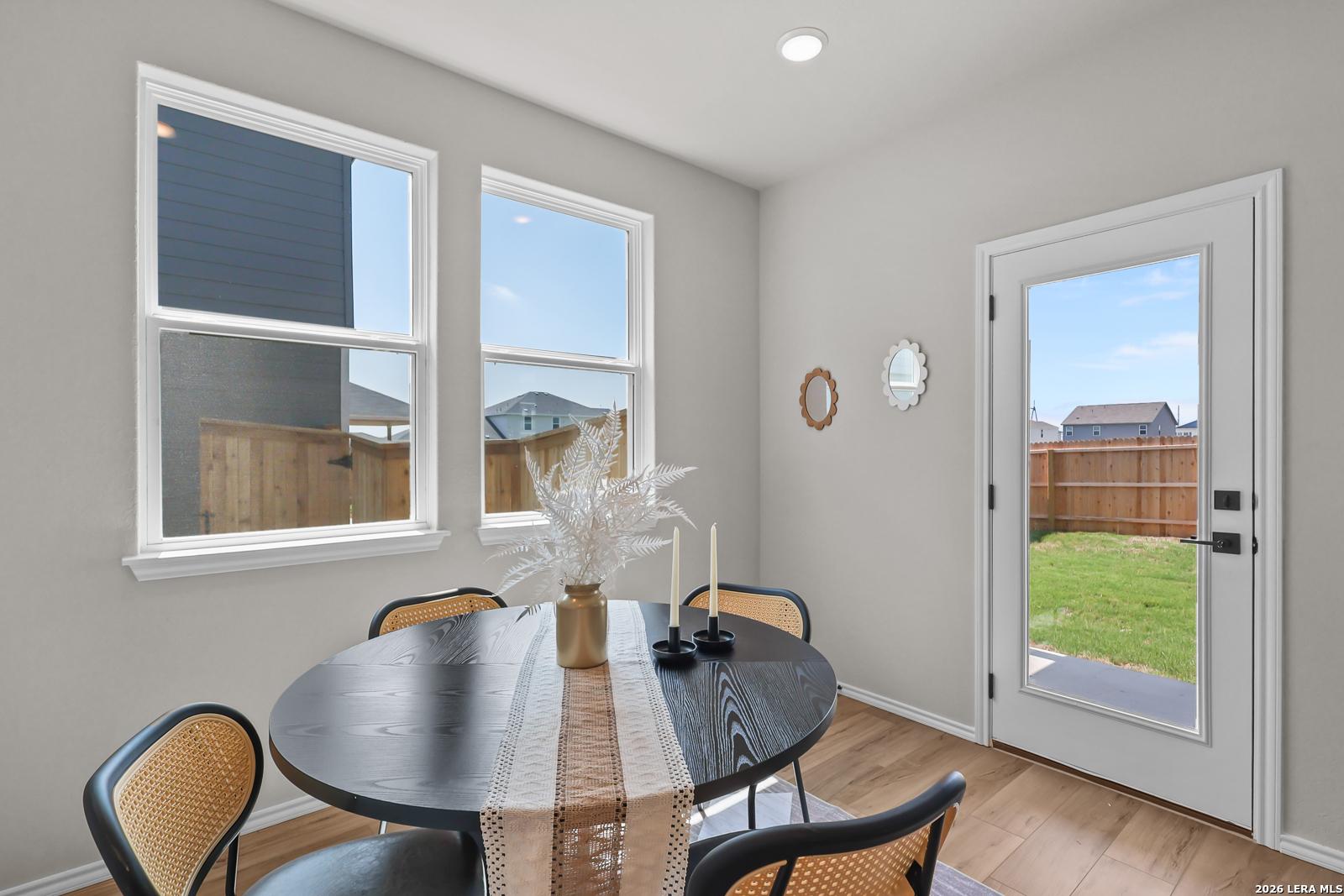 Bright breakfast nook with round dining table in The Daphne H floor plan by Davidson Homes in Hannah Heights, Seguin, TX.