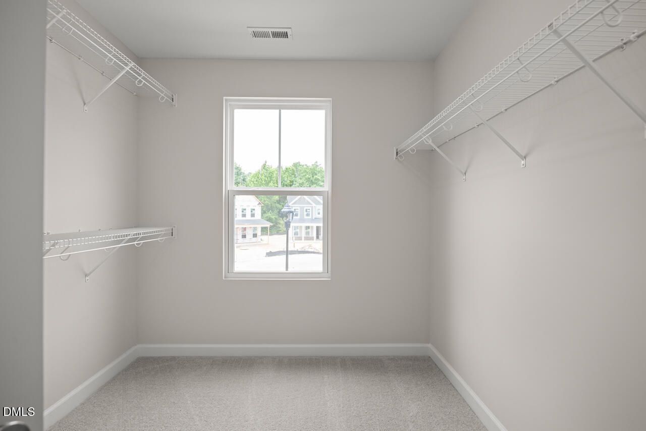 Walk-in closet with wire shelving in The Willow B floor plan at Woodland Crossing in Zebulon, North Carolina.