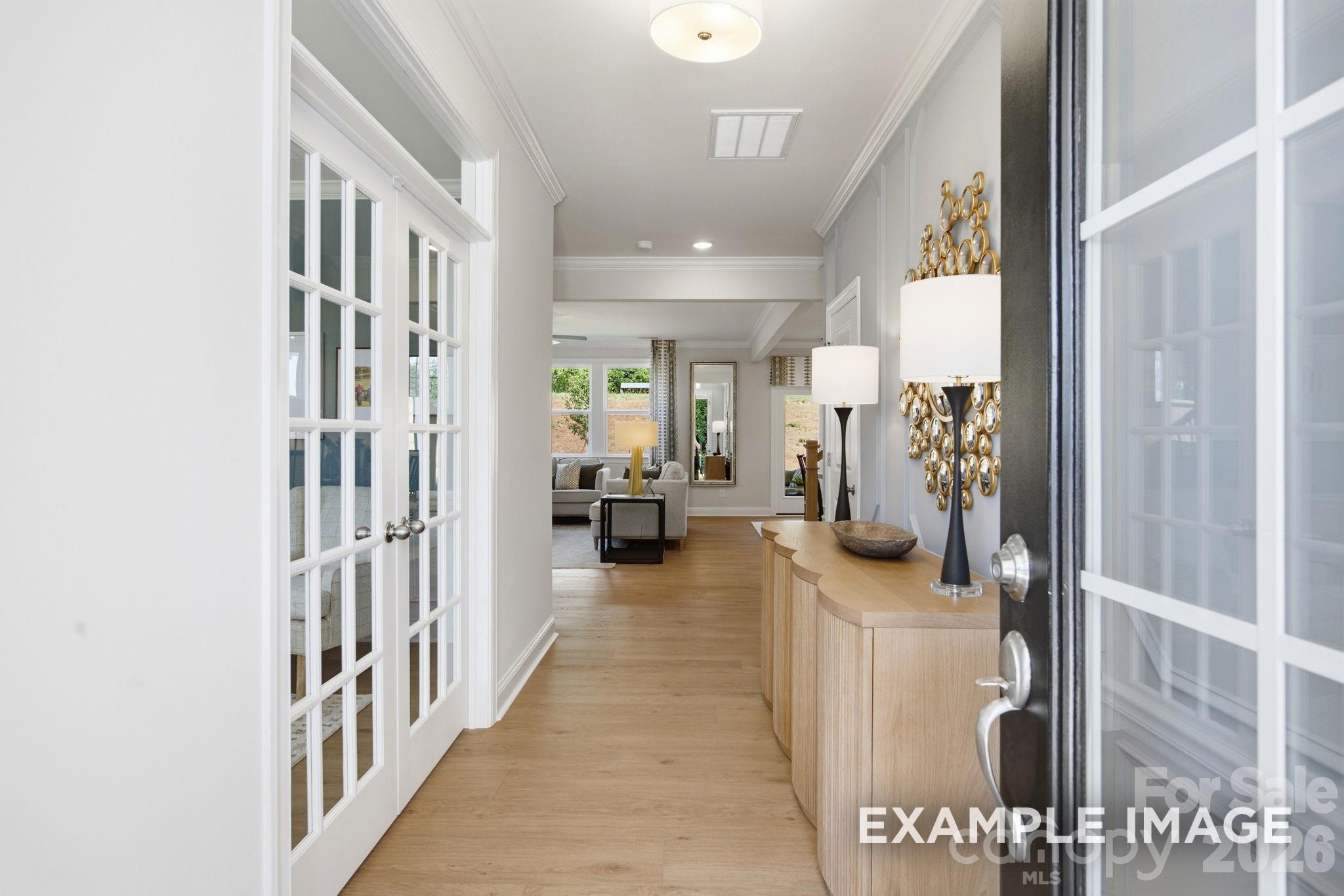 Bright foyer entry with French doors and hardwood floors in The Hickory B II floor plan at Windgate, Mooresville, NC.