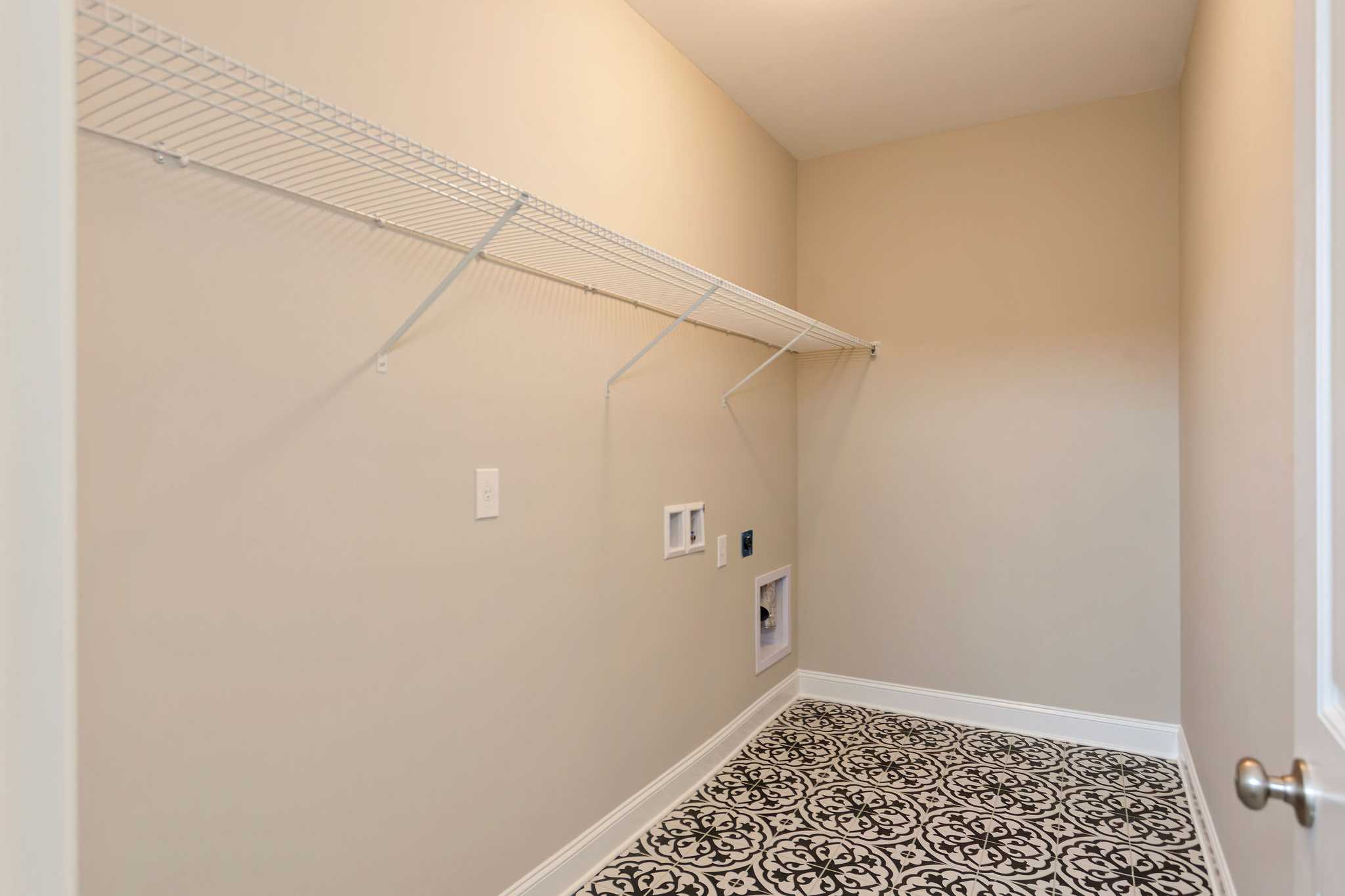 Davidson Homes The Emory Floor Plan Unfurnished Laundry Room with patterned tile floors and wall shelving