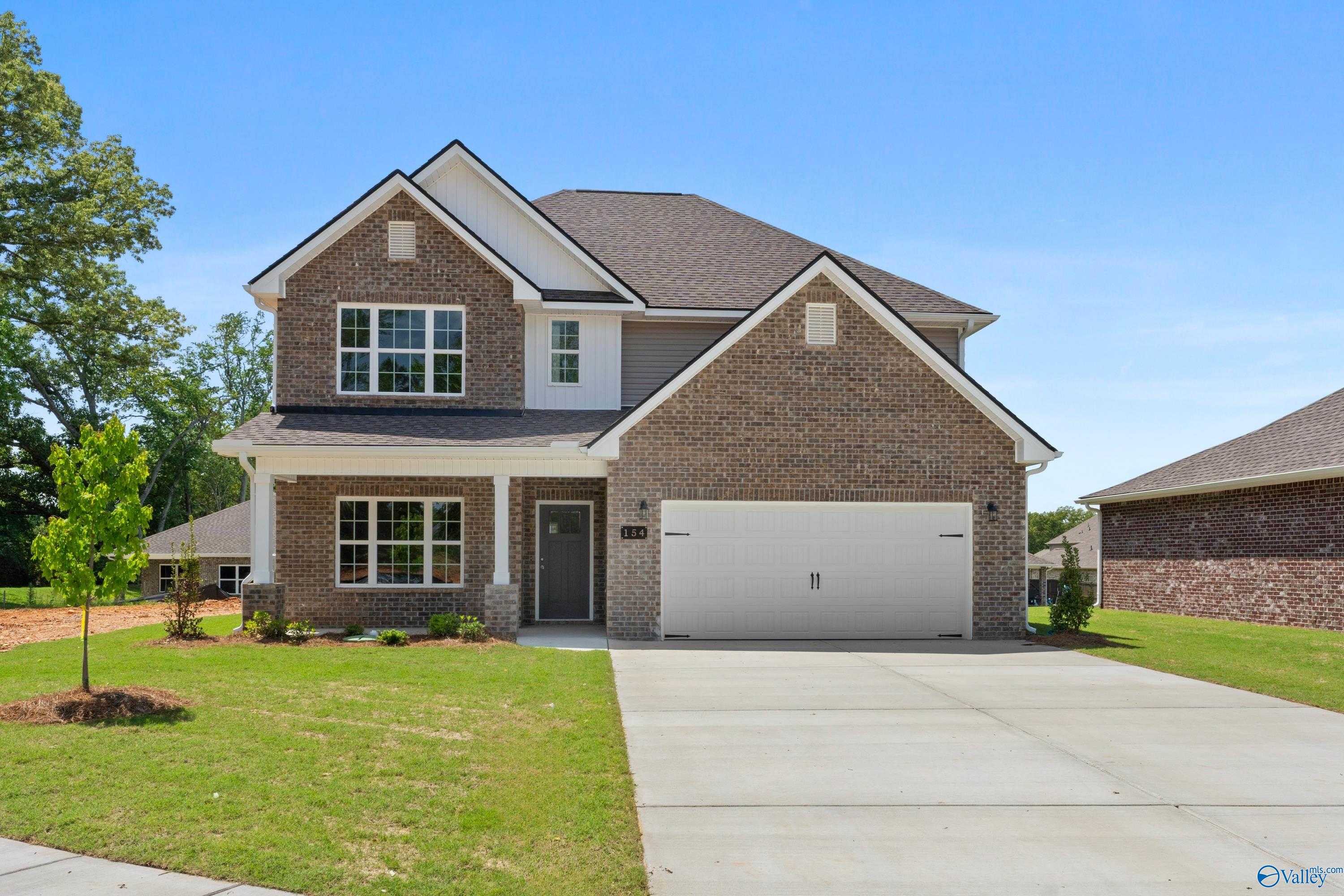 Two-story brick home with 2-car garage, driveway, and landscaped front yard in Creek Grove, New Market, Alabama - Davidson Homes The Chelsea B