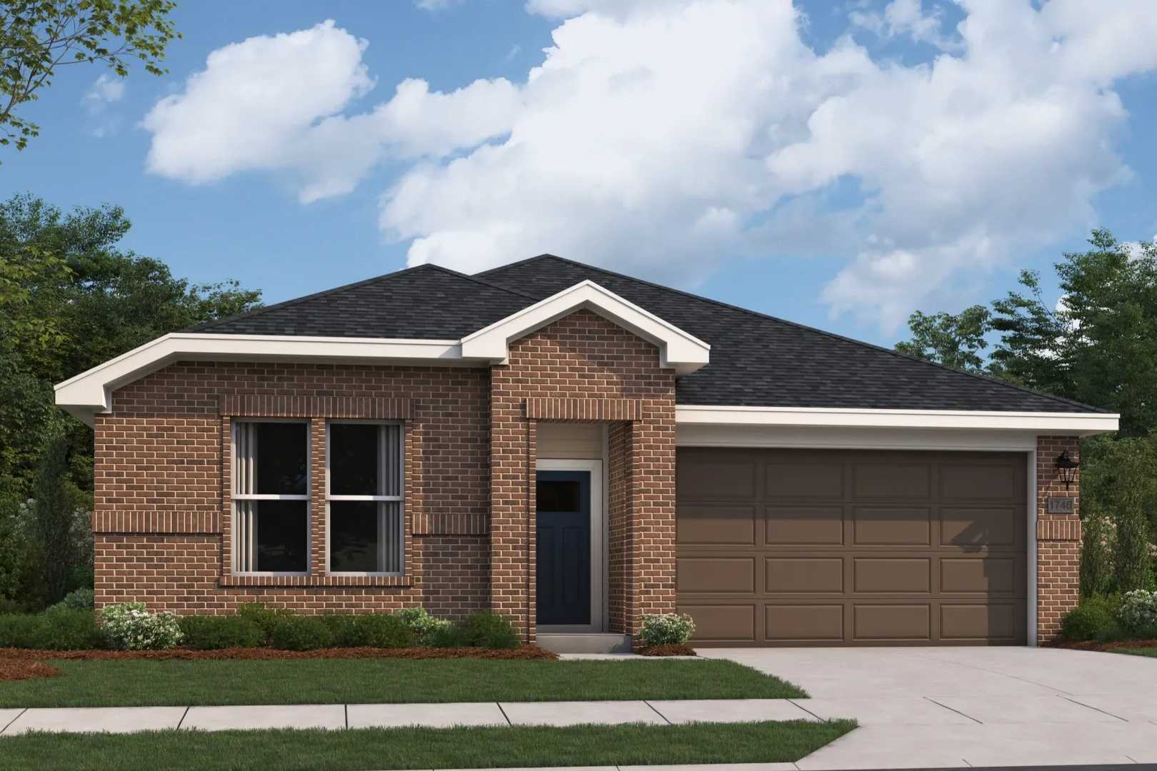 Brick ranch home exterior at Anderson Lakes in Opelika AL by Davidson Homes with attached garage and lush landscaping