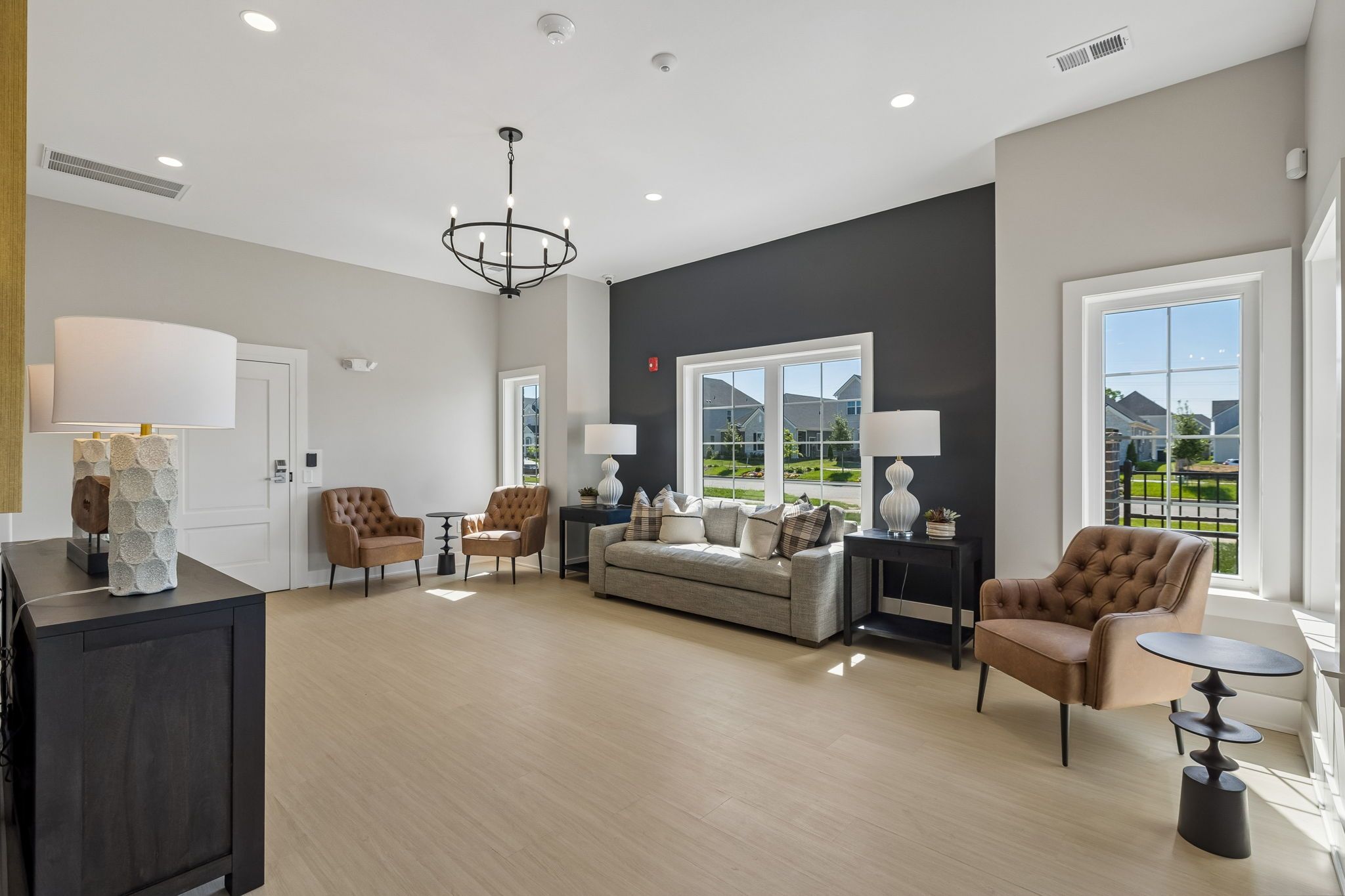 Modern clubhouse lounge at Bradshaw Farms in Mt. Juliet, TN by Davidson Homes with elegant seating and accent wall.