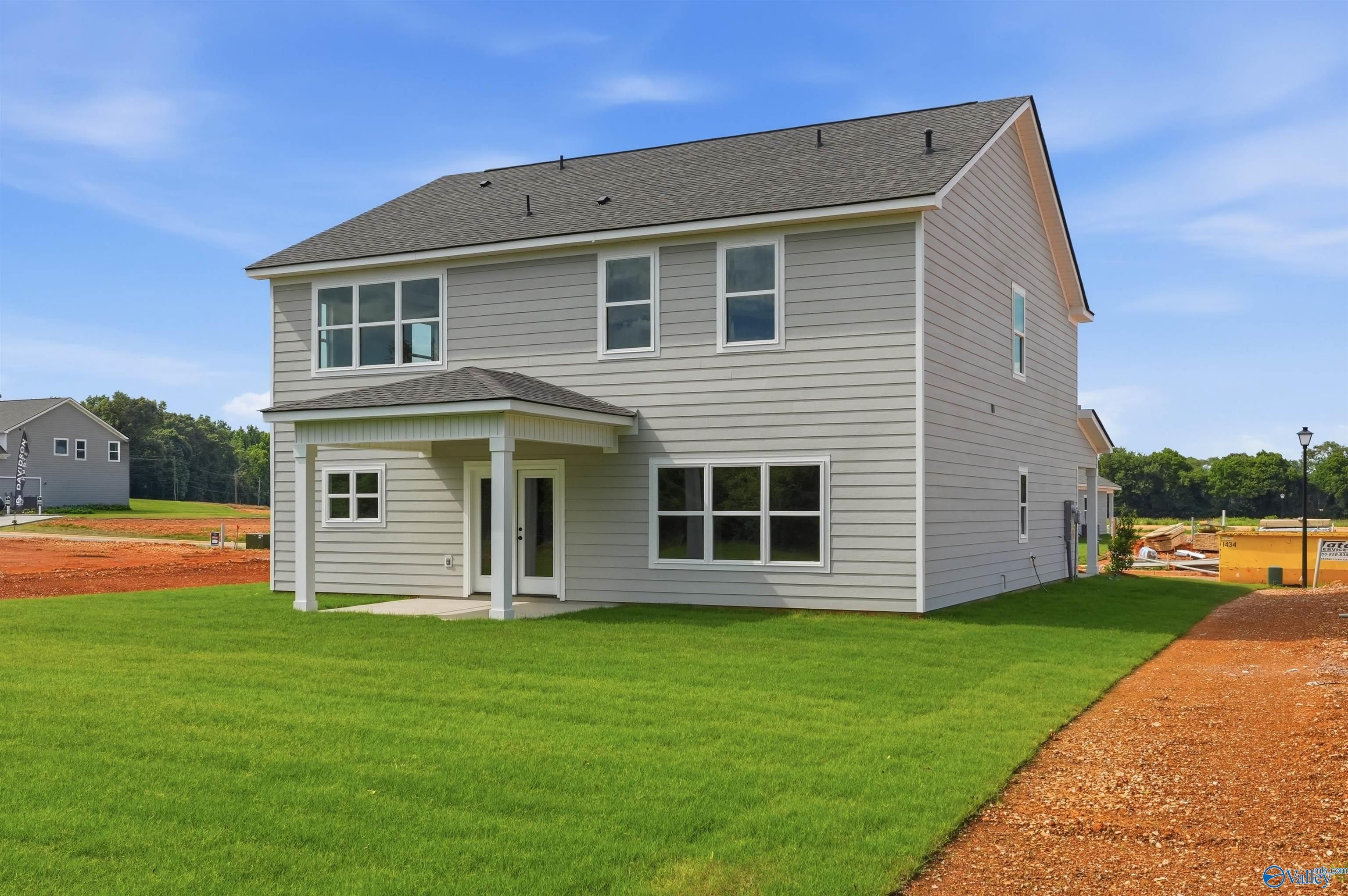 Exterior view of The Chelsea D floor plan by Davidson Homes featuring a covered back patio in Berry Cove, New Market, AL.
