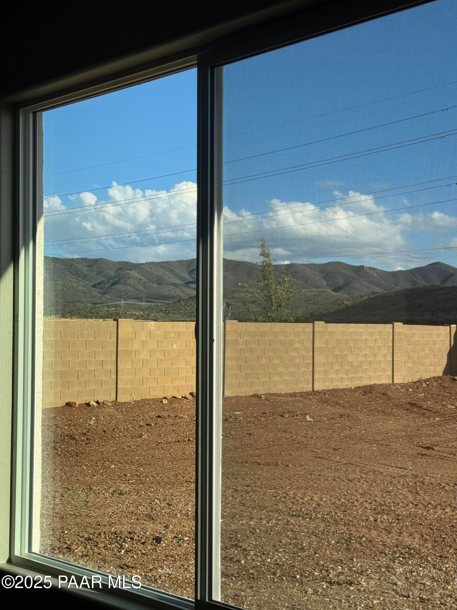 Scenic mountain vista through large sliding window in 3-bedroom Evermore Homes The Sunrise A, Prescott Valley, Arizona