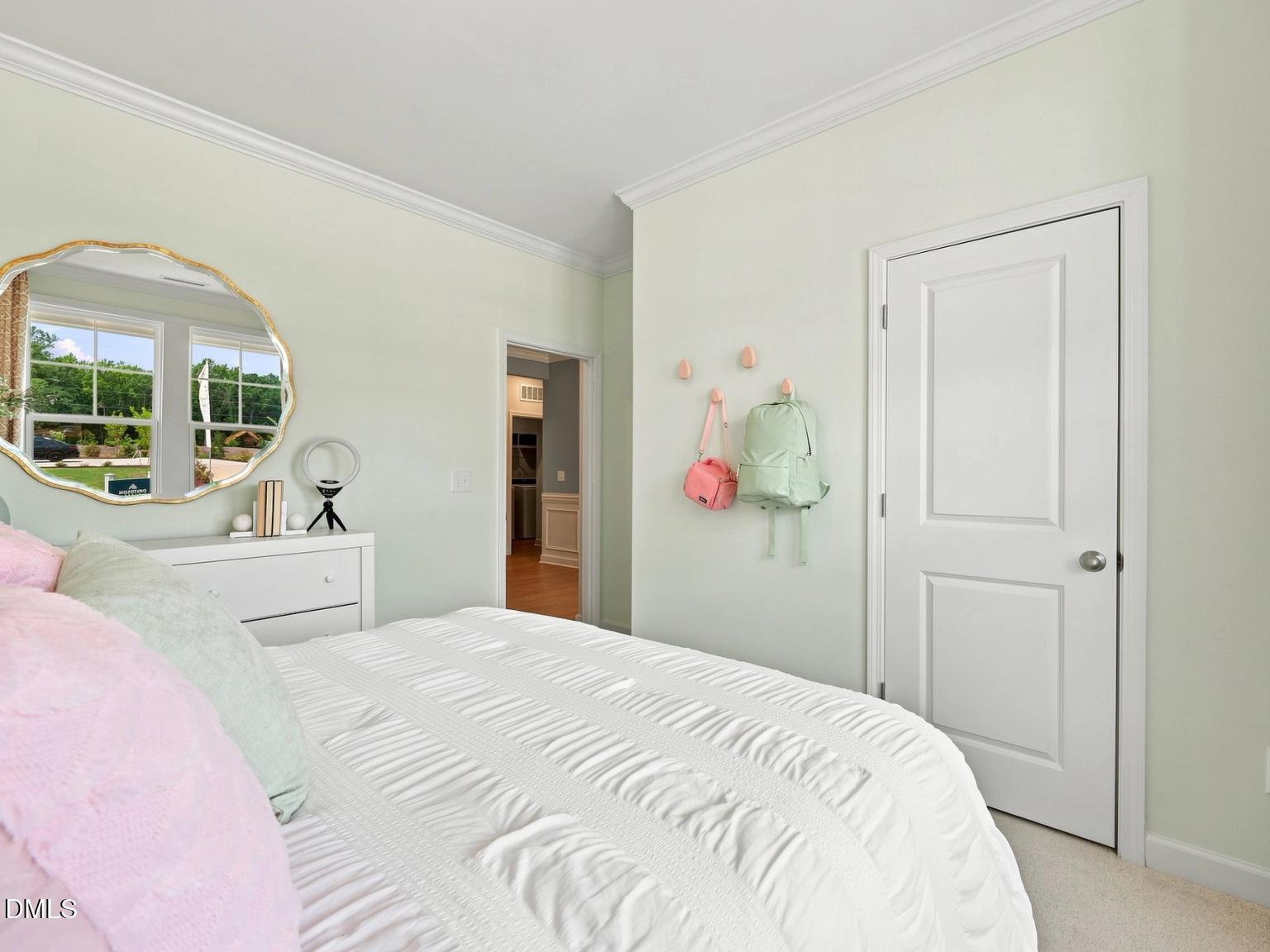 Bright bedroom with white bedding and decor in The Daphne C floor plan by Davidson Homes, Woodland Crossing, Zebulon, NC.