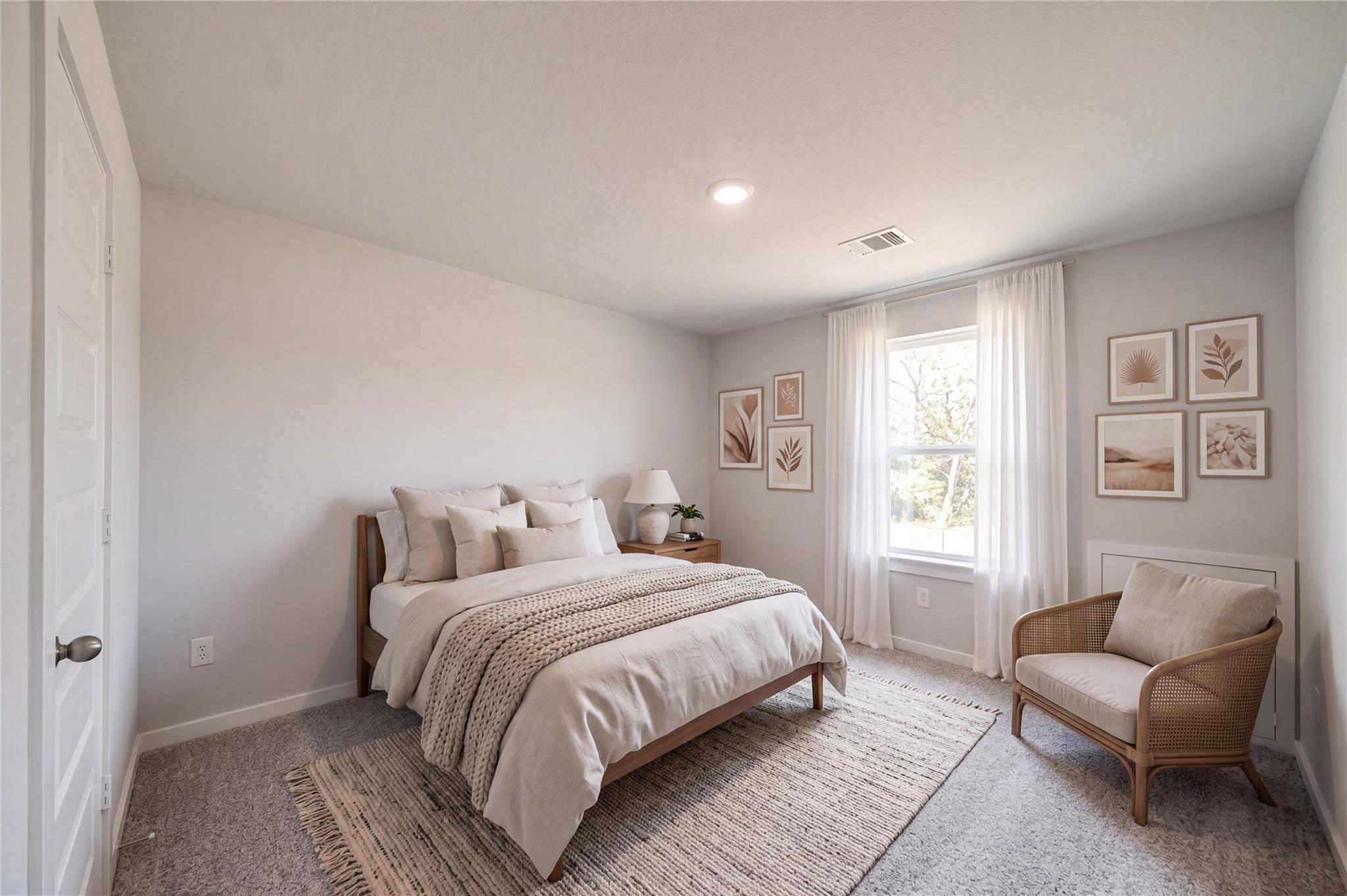 Serene neutral-toned bedroom with wood bed, accent chair, and gallery wall in Davidson Homes The Sabine F, Cleveland, Texas