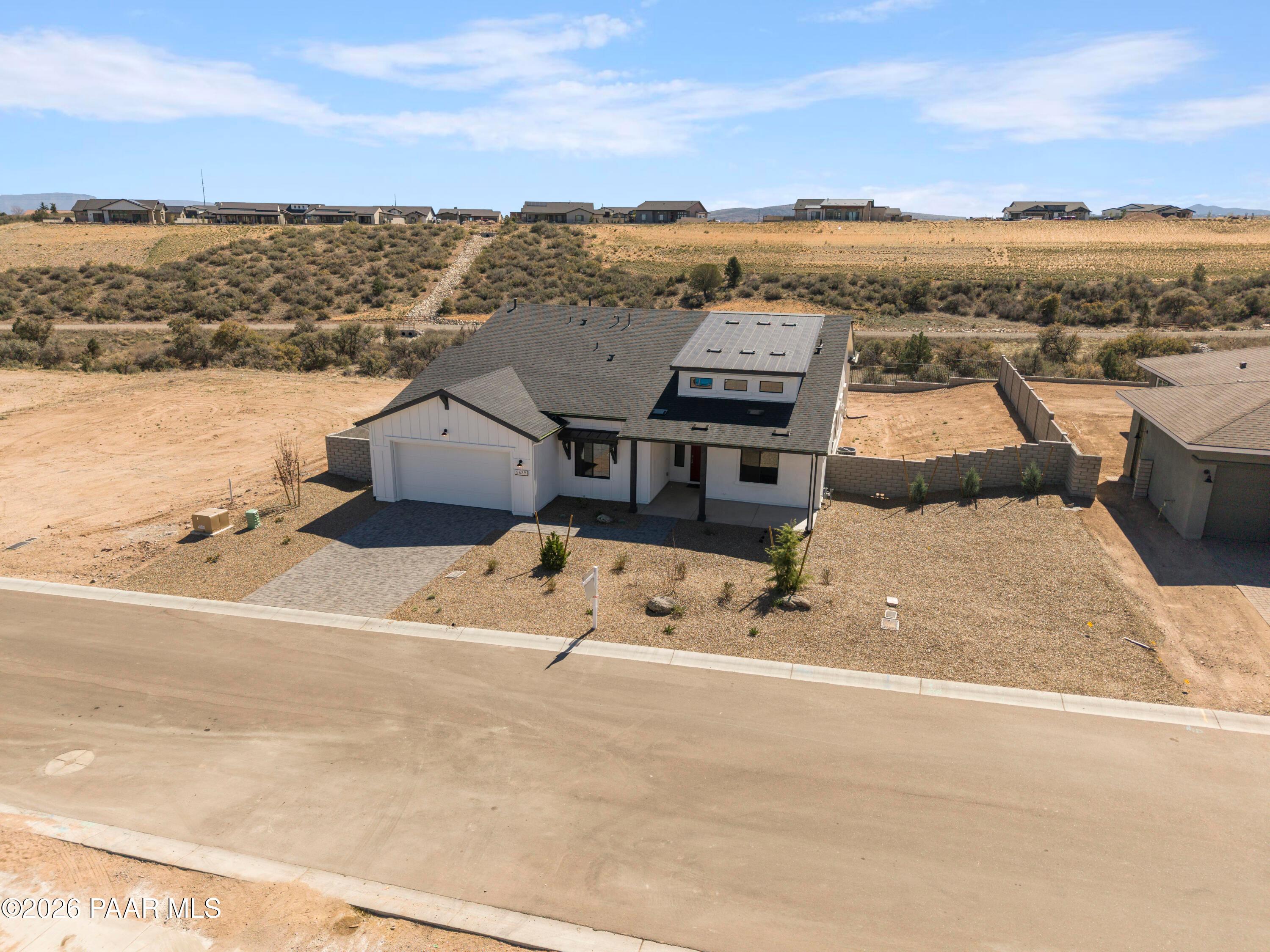 Modern single-story Soleil E home by Davidson Homes in Hidden Hills, Prescott, AZ, featuring solar panels, 3-car garage, desert landscaping