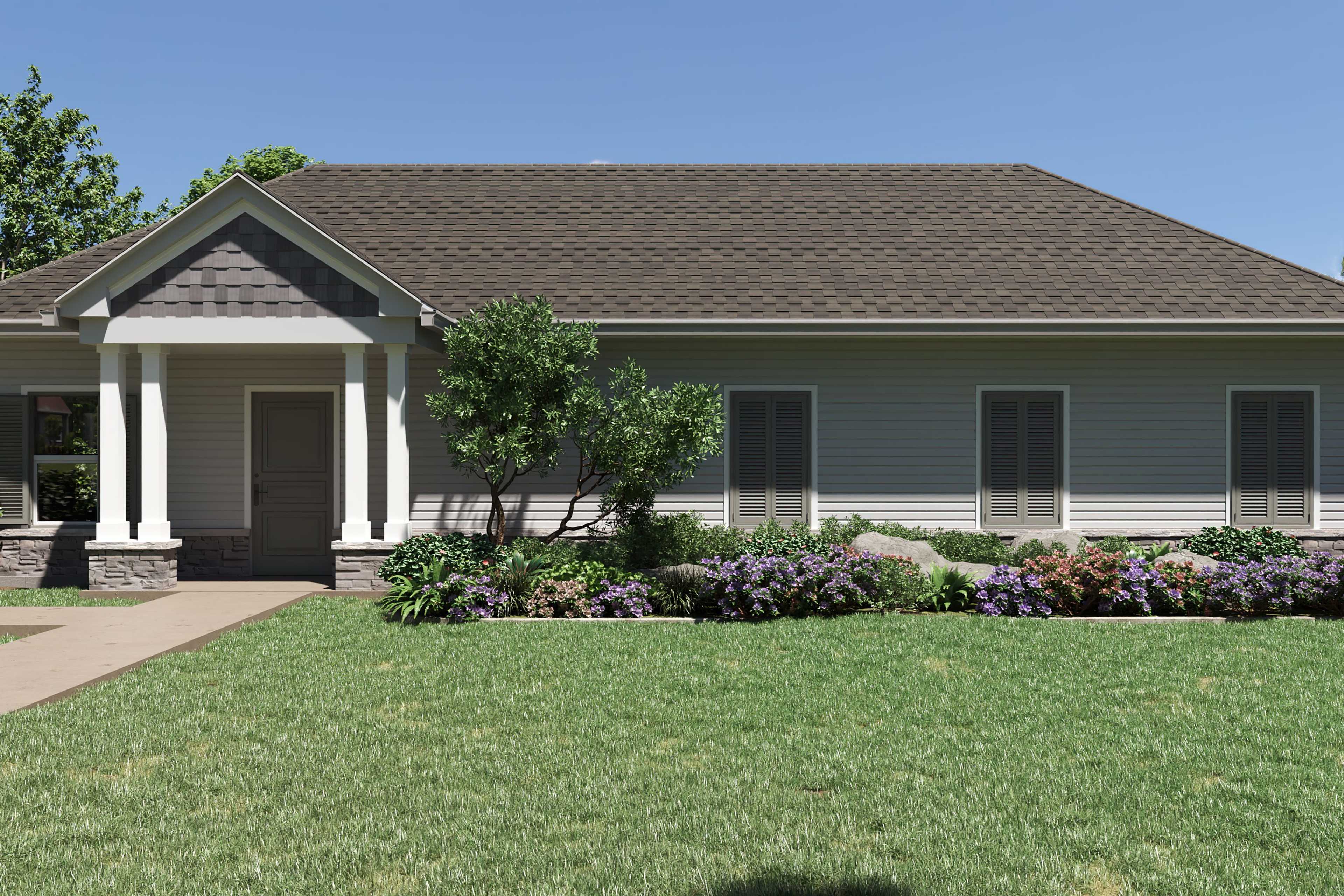 Single-story craftsman home exterior at Kelly Preserve in Loganville GA with columned porch, gray siding, and lush landscaped yard