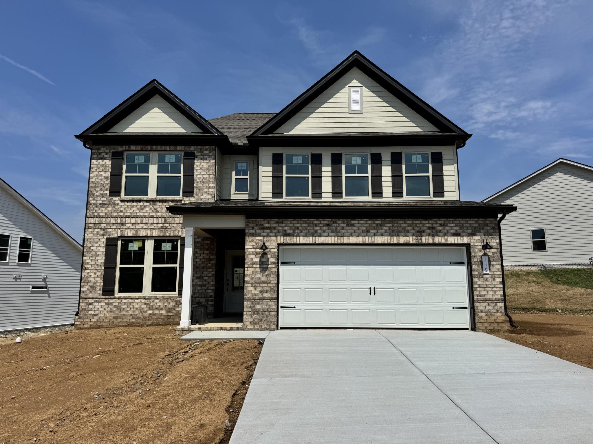 Two-story brick exterior of The Willow C floor plan by Davidson Homes in Woods Crossing, Gallatin, Tennessee.