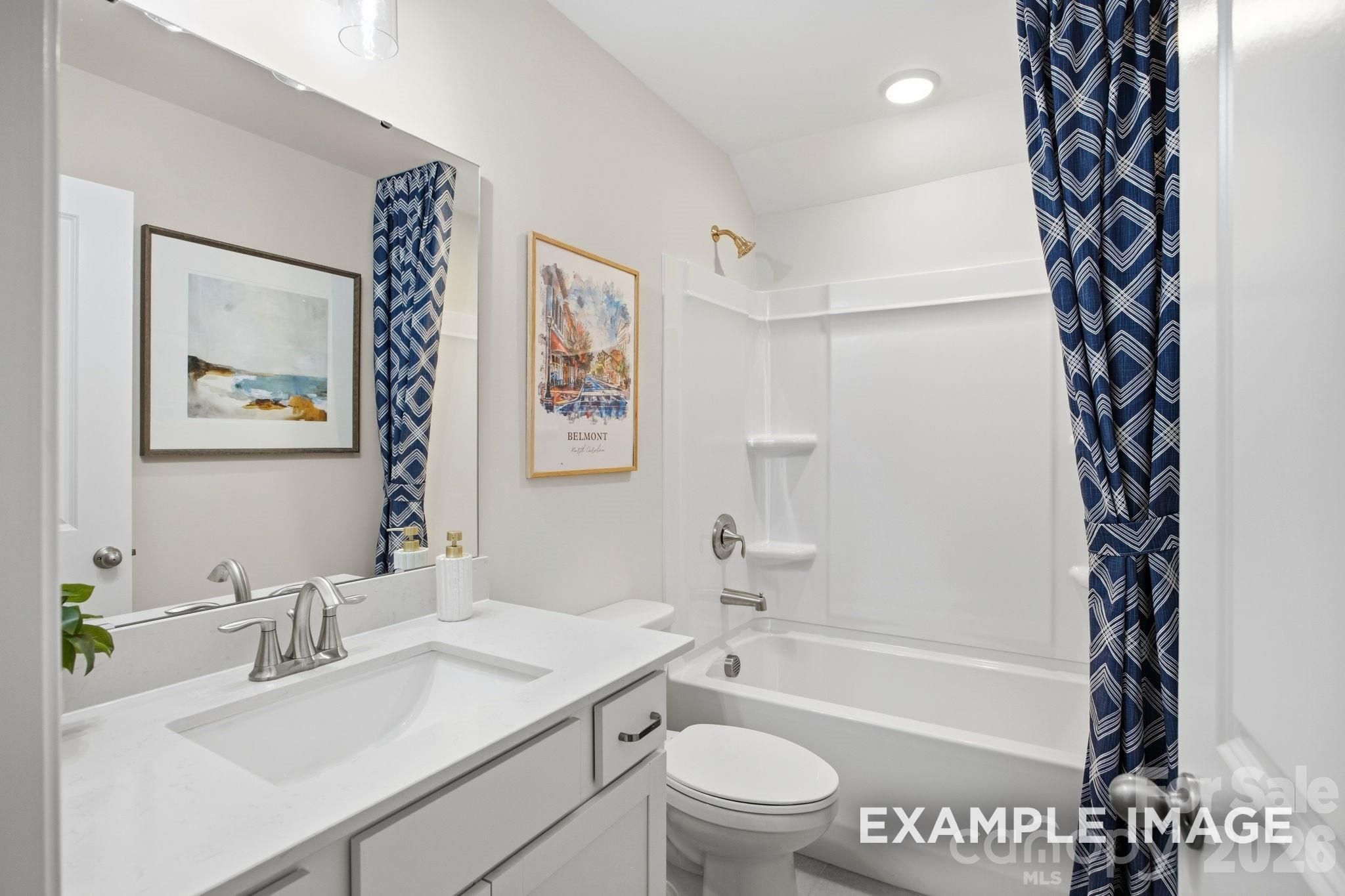 Modern full bathroom with white vanity and tub-shower combo in The Hickory B II floor plan by Davidson Homes in Mooresville.