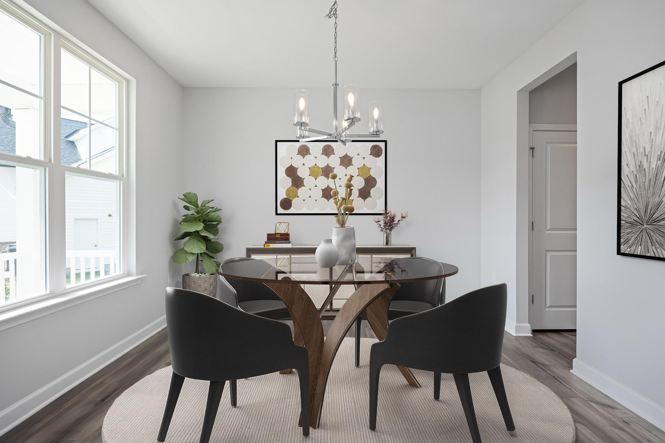 Elegant dining room at Stagecoach Corner in Mebane NC with glass table, black chairs, modern chandelier, and abstract art