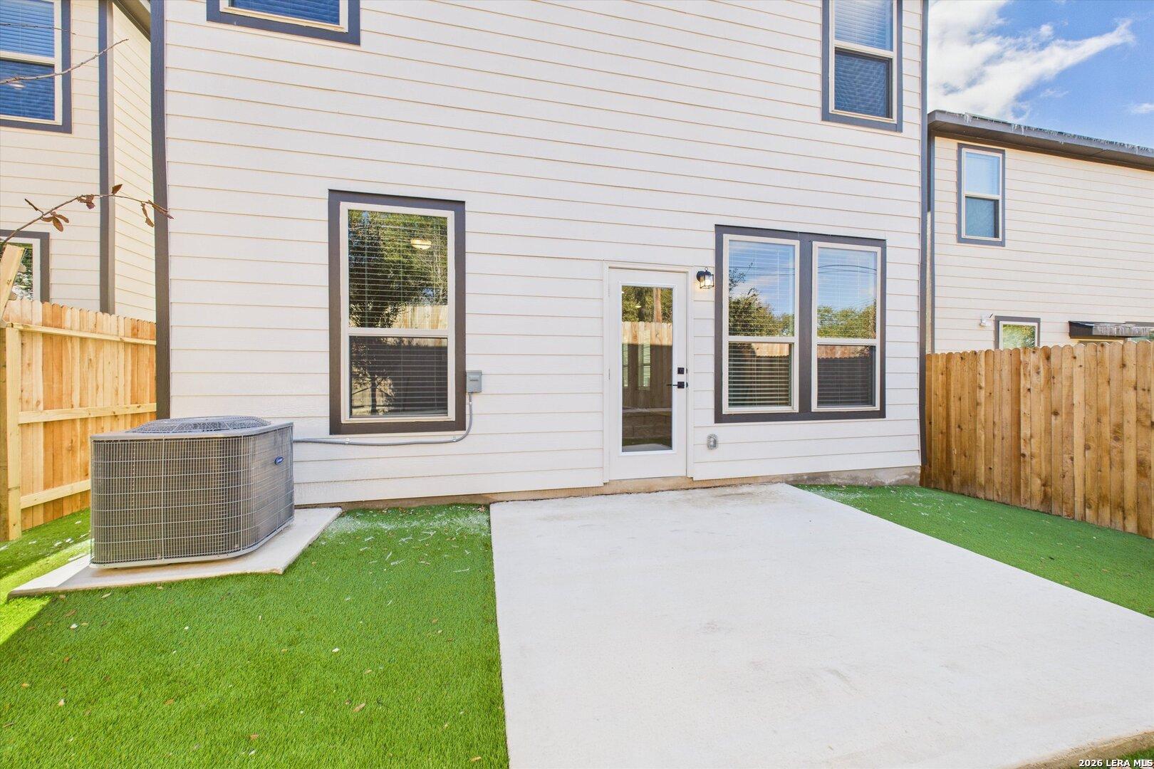 Covered back patio with glass door and large windows in The Gillian B 4-bedroom home, Meadows at Oak Creek, San Antonio