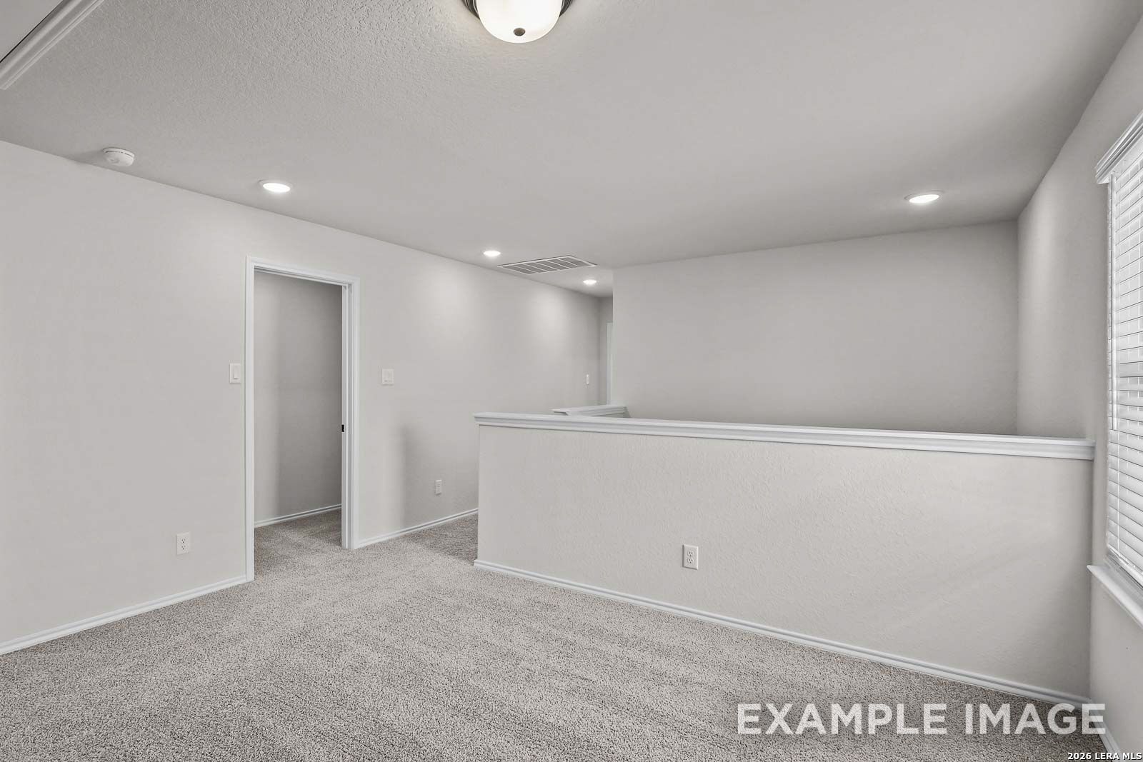 Spacious carpeted upstairs loft in The Florence A floor plan by Davidson Homes in Cedar Heights, San Antonio, Texas.