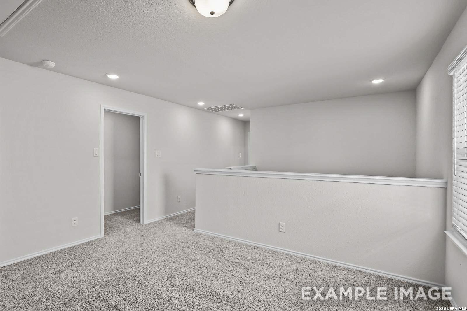 Spacious carpeted upstairs loft in The Florence A floor plan by Davidson Homes in Cedar Heights, San Antonio, Texas.