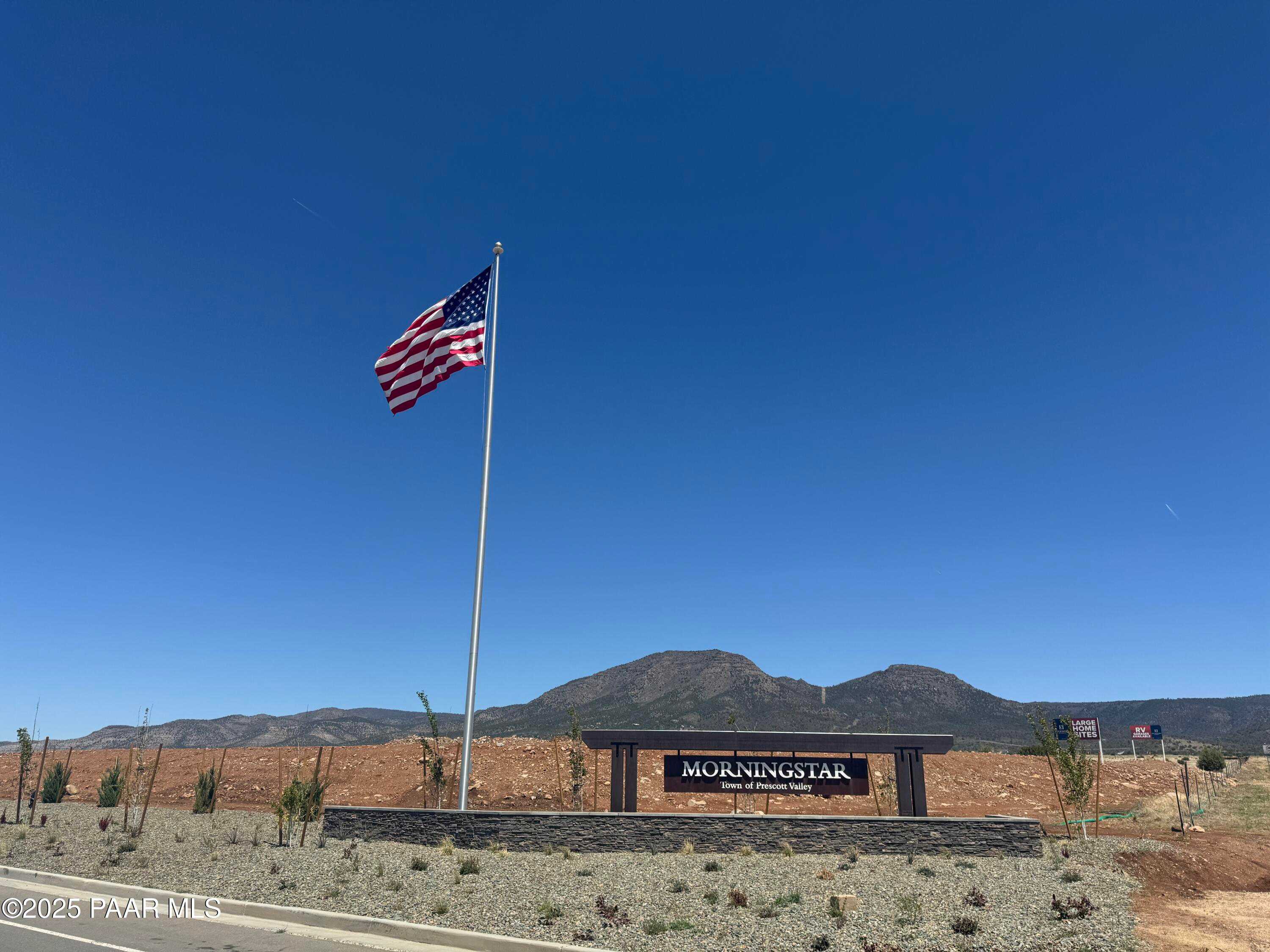 Morningstar community entrance with American flag and mountain backdrop in Prescott Valley, Arizona