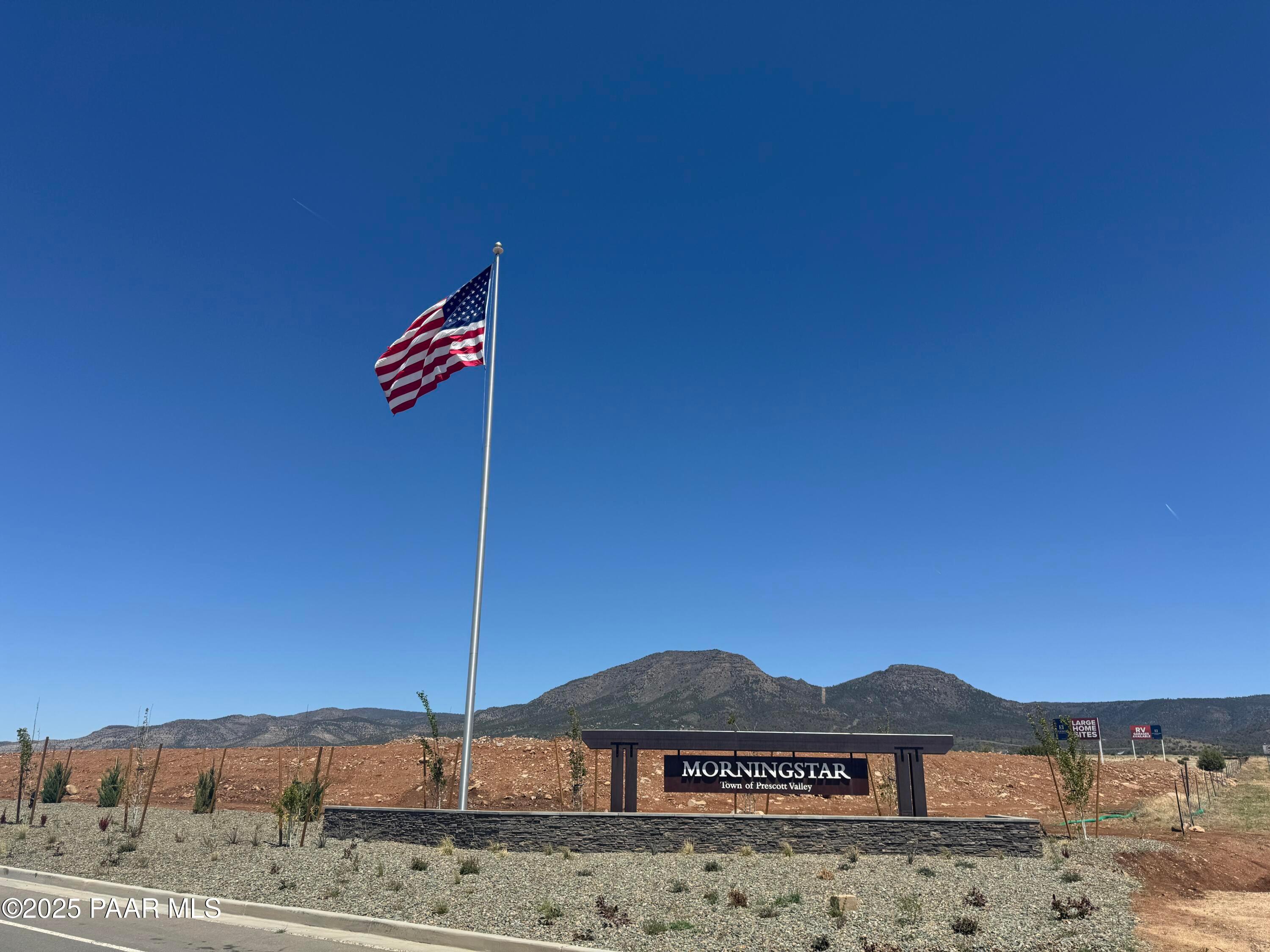 Morningstar community entrance with American flag and mountain backdrop in Prescott Valley, Arizona