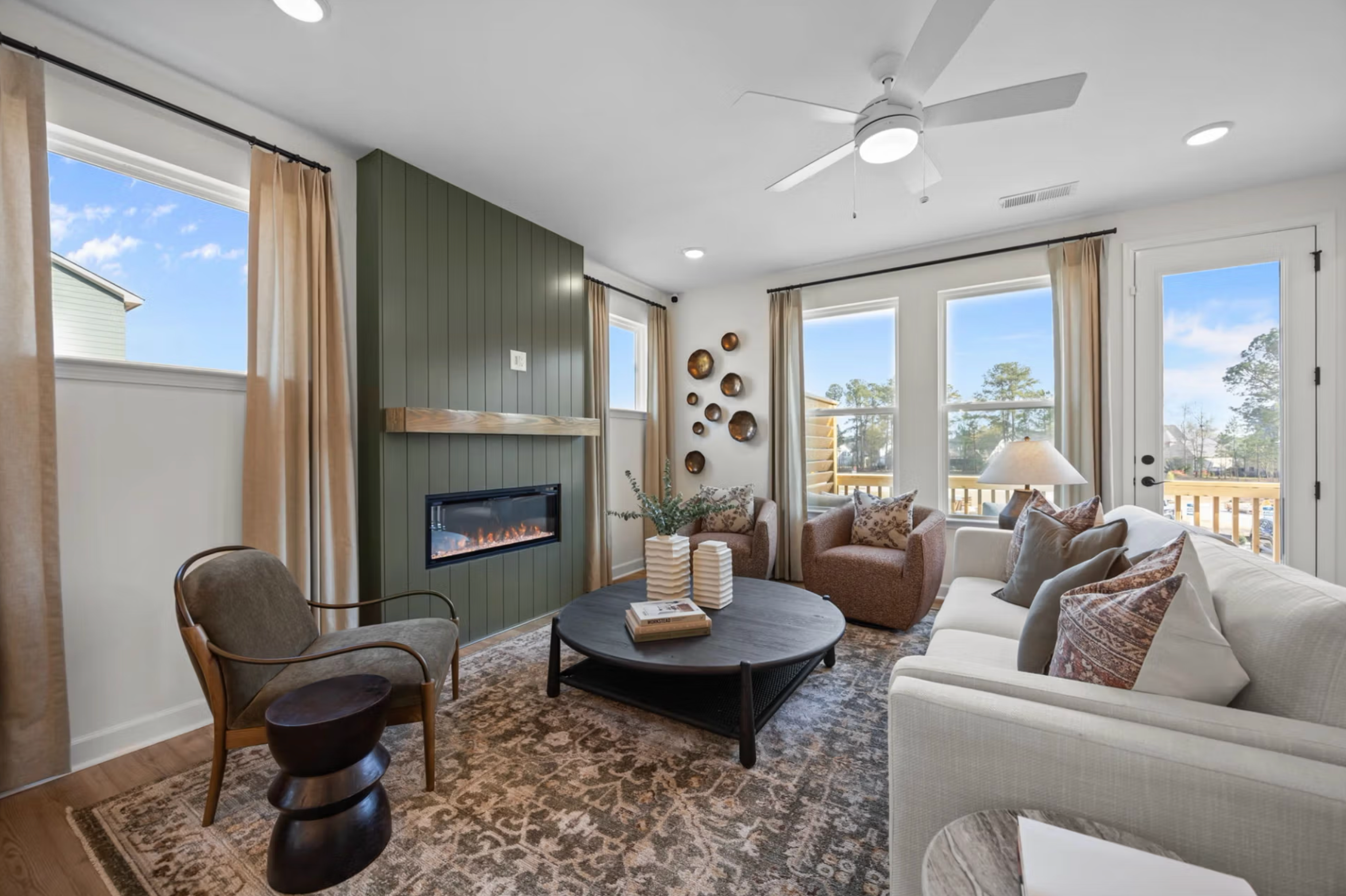 Modern white kitchen in Camden Park, Knightdale NC with shaker cabinets, large island bar, stainless steel appliances, hardwood floors