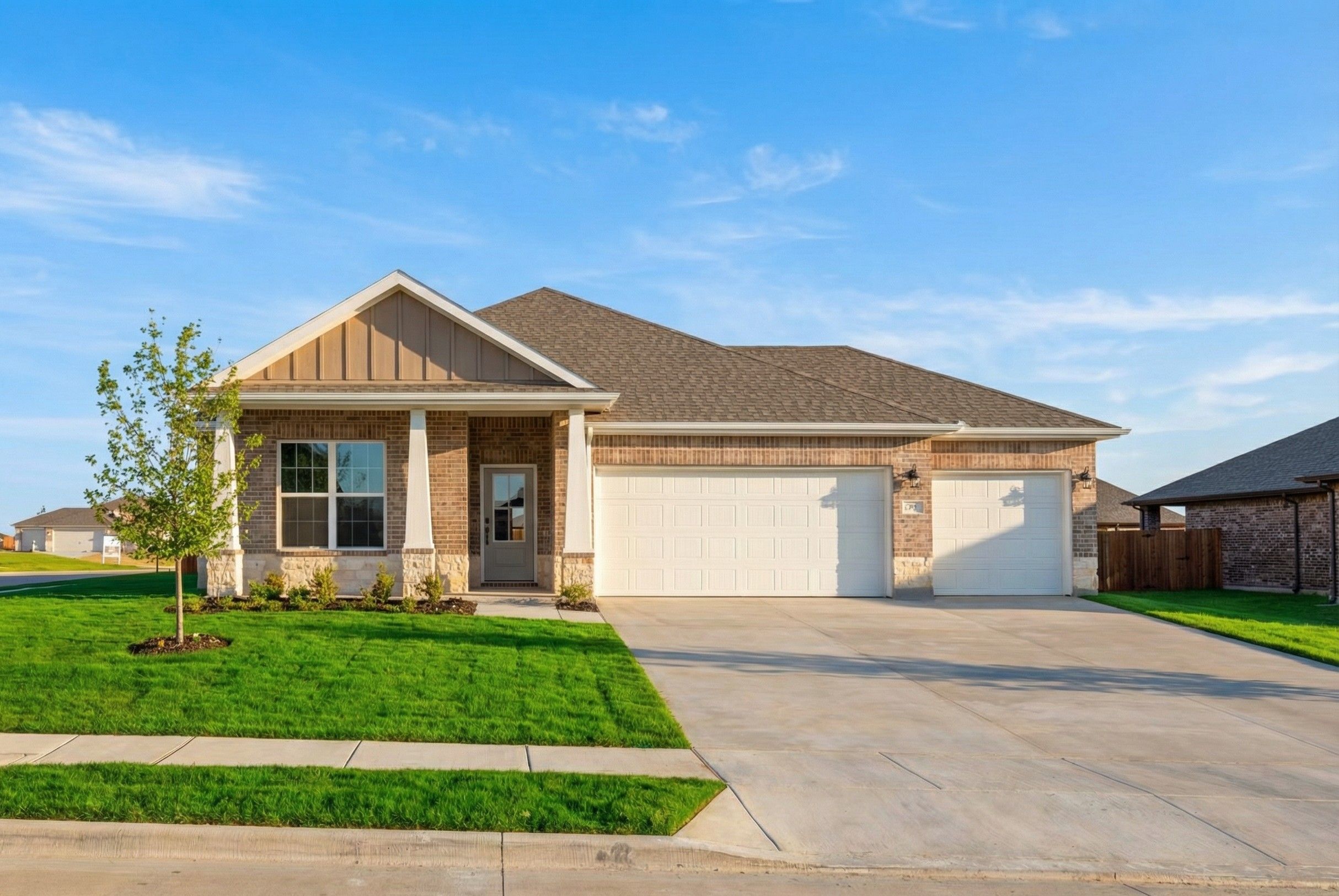 Modern single-story home exterior at Waverly Estates in Josephine Texas with covered porch, two-car garage, and lush green lawn