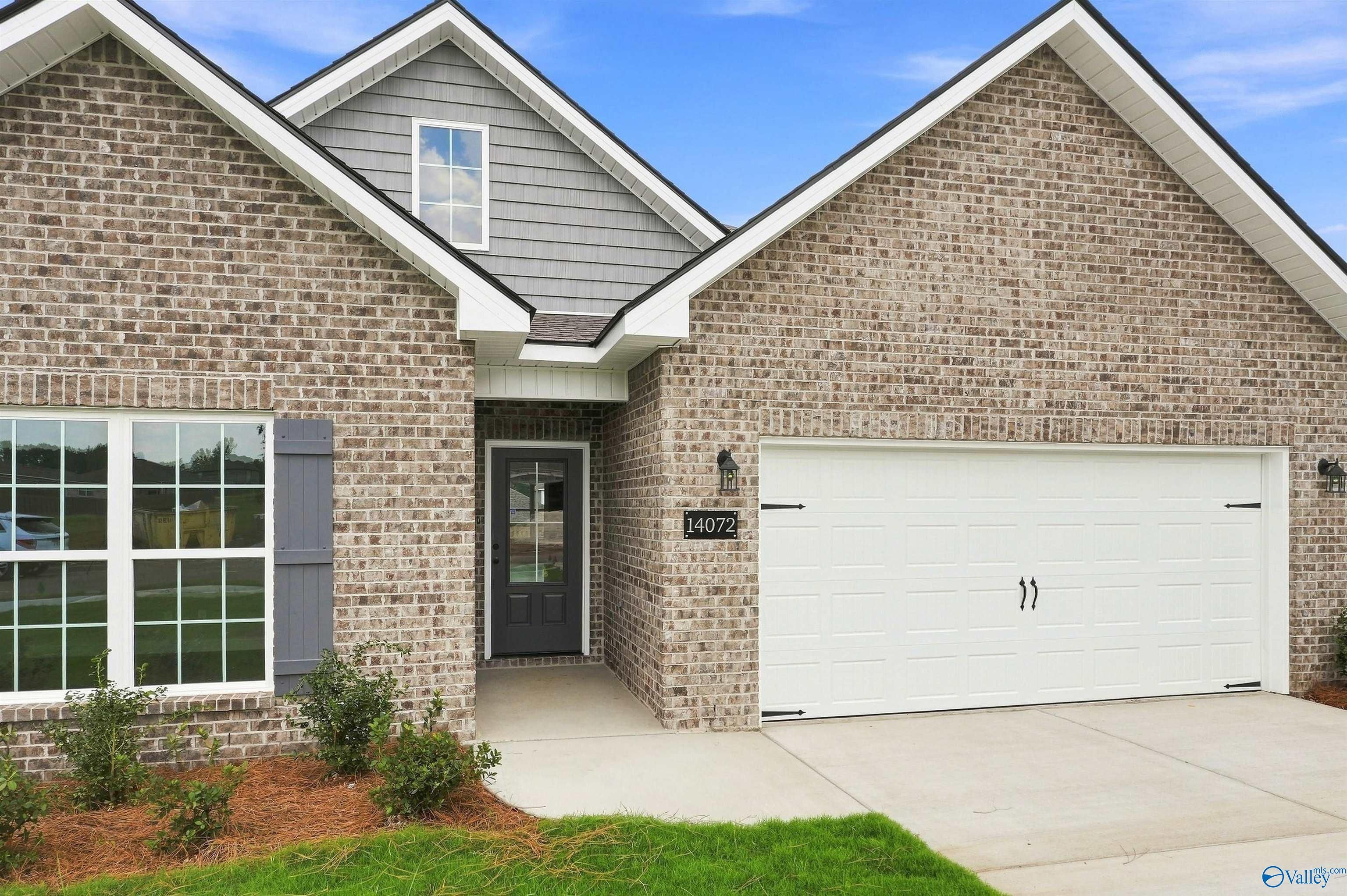 Brick exterior with 2-car garage and covered entry of Davidson Homes Franklin C plan in The Meadows, Athens, Alabama