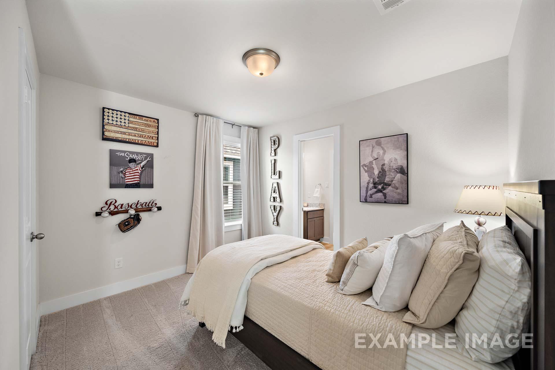 Cozy boy's bedroom in The Lily A home by Davidson Homes, Cypress TX: baseball decor, plush bed, sheer curtains, soft lighting