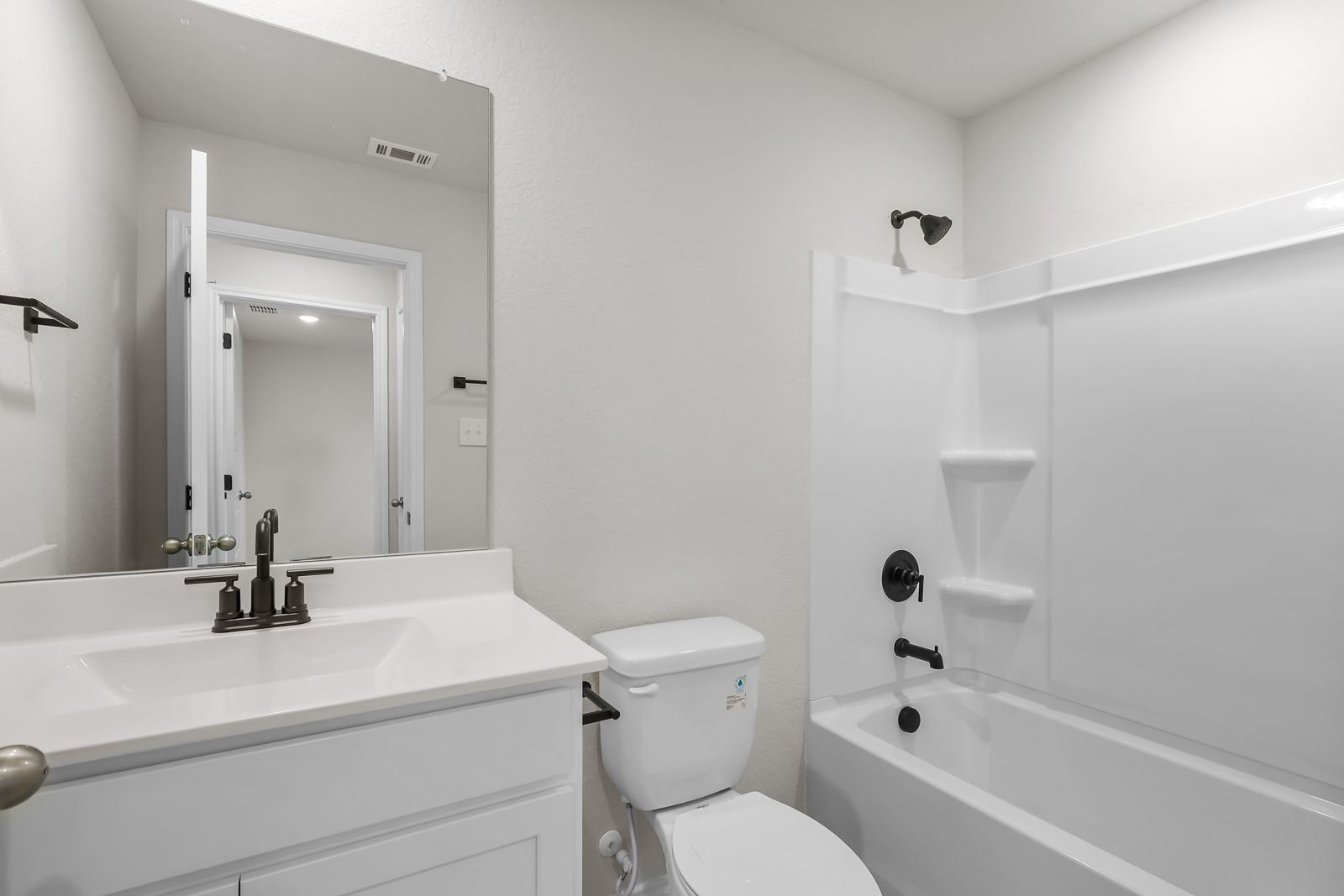 Full bathroom in The Sequoia C featuring white vanity, modern matte black fixtures, and a shower-tub combination.