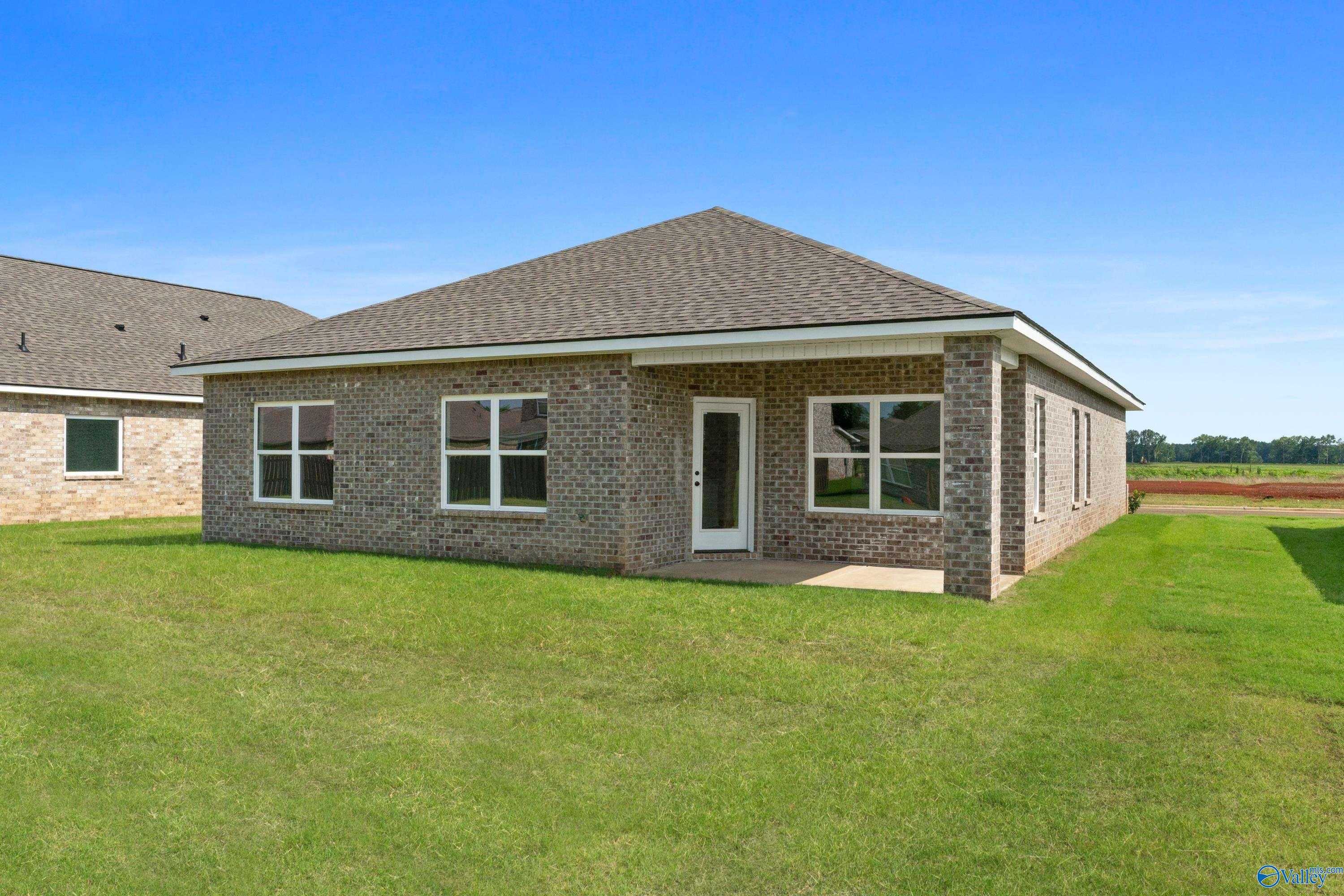 Single-story brick Davidson Homes The Franklin B with covered porch and green lawn in Clearview, Hazel Green, Alabama