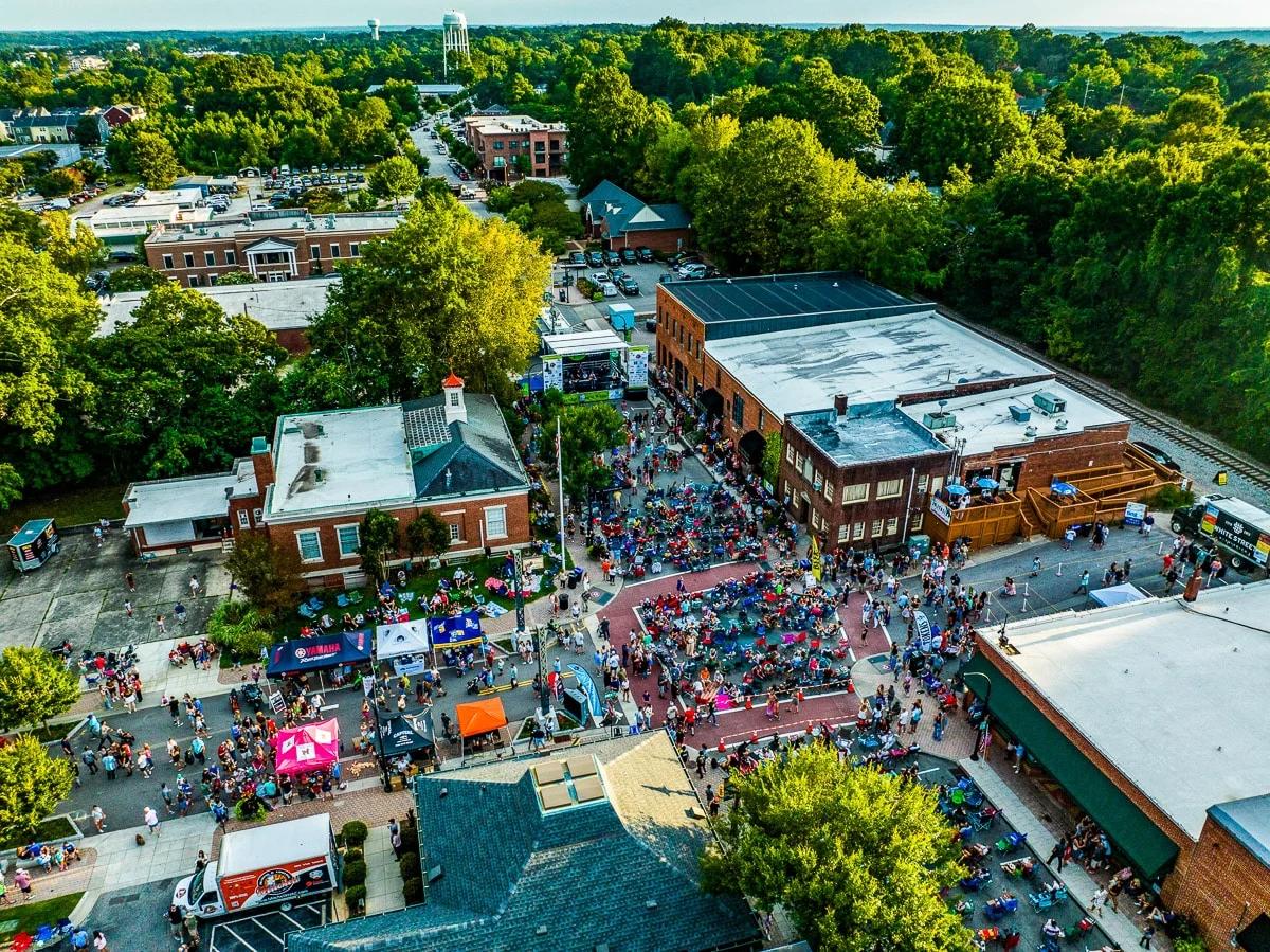 Aerial view of a lively outdoor community event in downtown Wake Forest, NC, near the Rockport neighborhood.