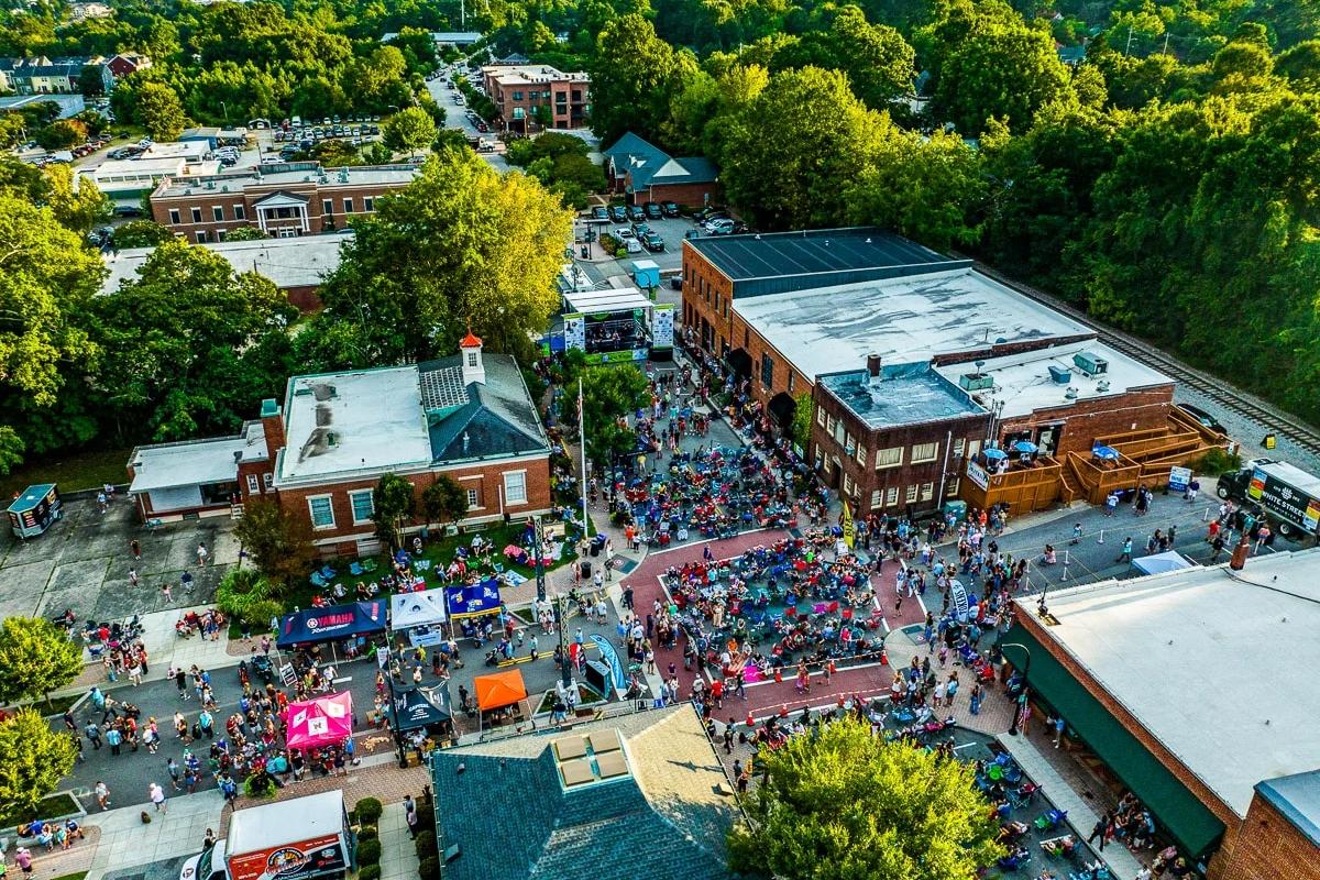 Aerial view of a lively outdoor community event in downtown Wake Forest, NC, near the Rockport neighborhood.