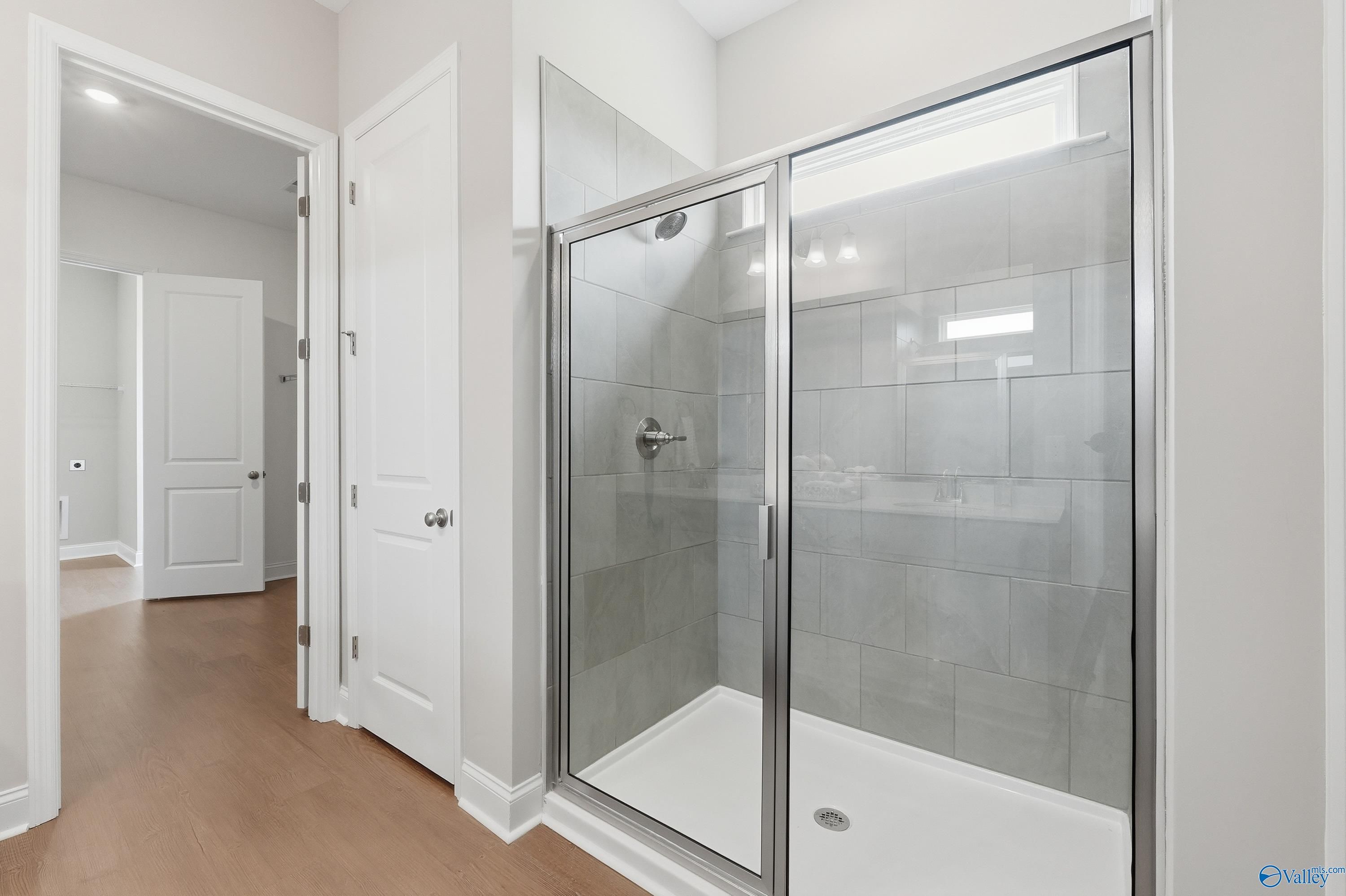 Modern glass walk-in shower with gray subway tiles and rainfall head in master bath, Davidson Homes The Arcadia B, Huntsville AL