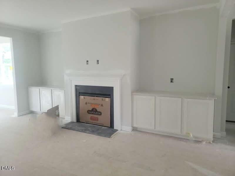 Living room with fireplace and built-in cabinets in The Crawford D floor plan by Davidson Homes in Angier, NC.
