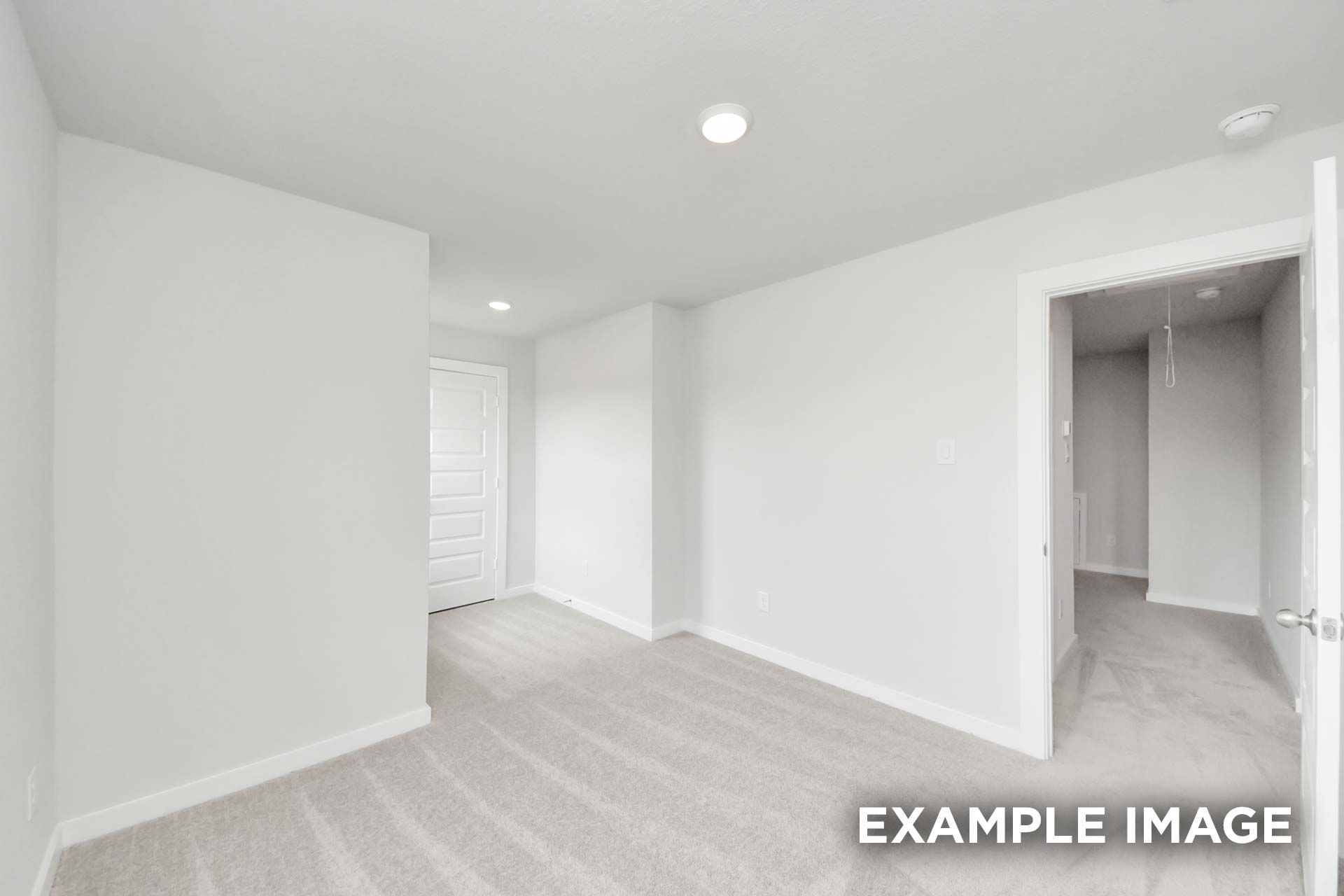 Spacious upstairs bedroom in The Blanco by Davidson Homes with neutral carpet, white walls, and walk-in closet access.