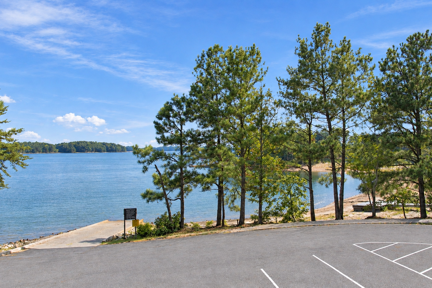 Lake Lanier boat ramp and parking area near Lake Hollow by Davidson Homes in Gainesville, Georgia, surrounded by pine trees