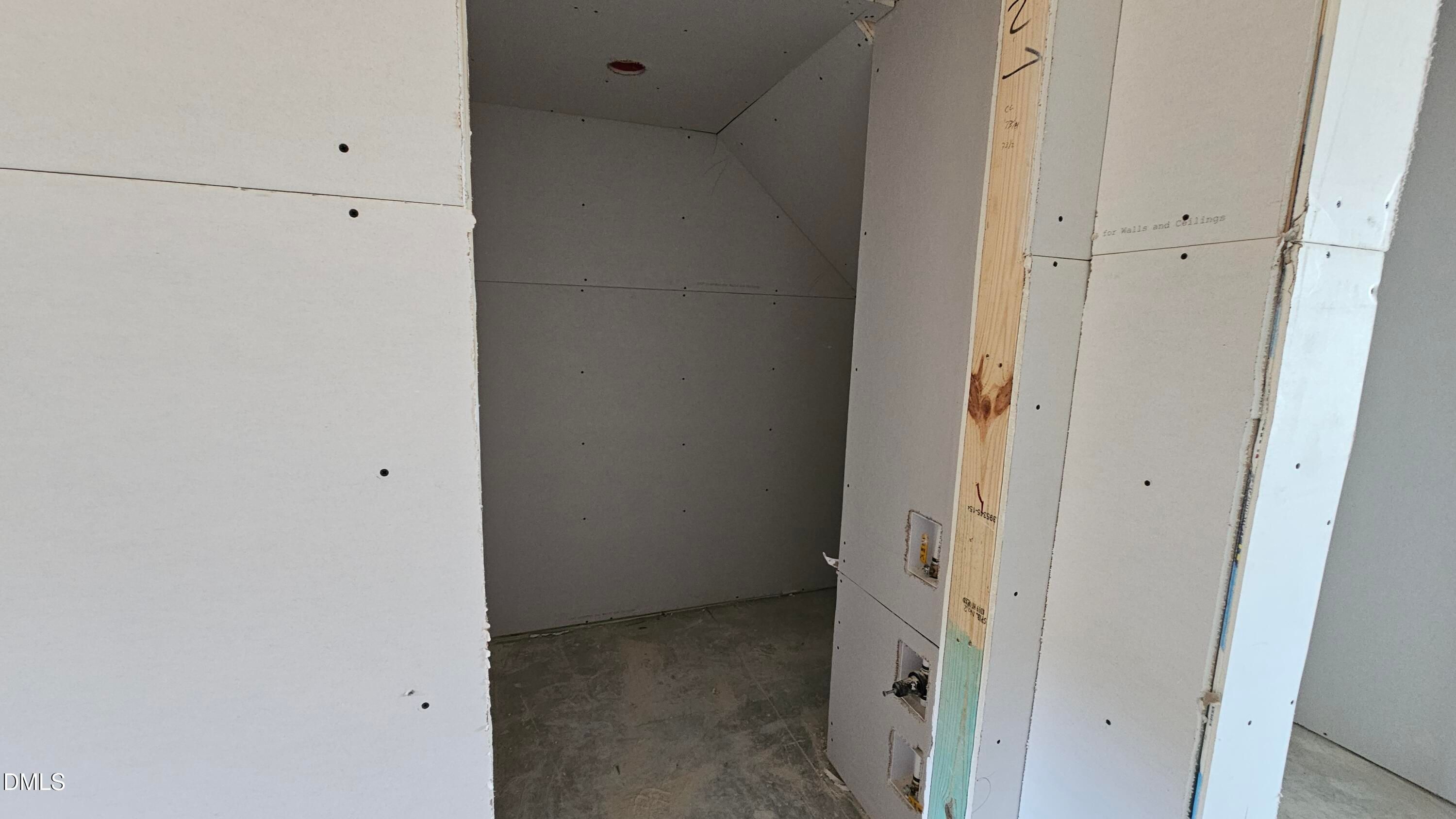 Drywall installation underway in an under-stair storage closet of The Graham floor plan in Springvale, Fuquay-Varina.
