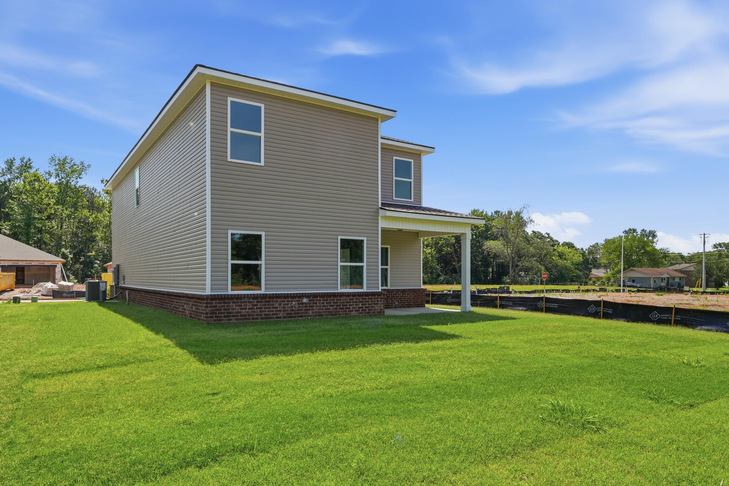 Rear exterior view of The Russell A, a 2-story single-family home with brick and siding in New Market, Alabama.