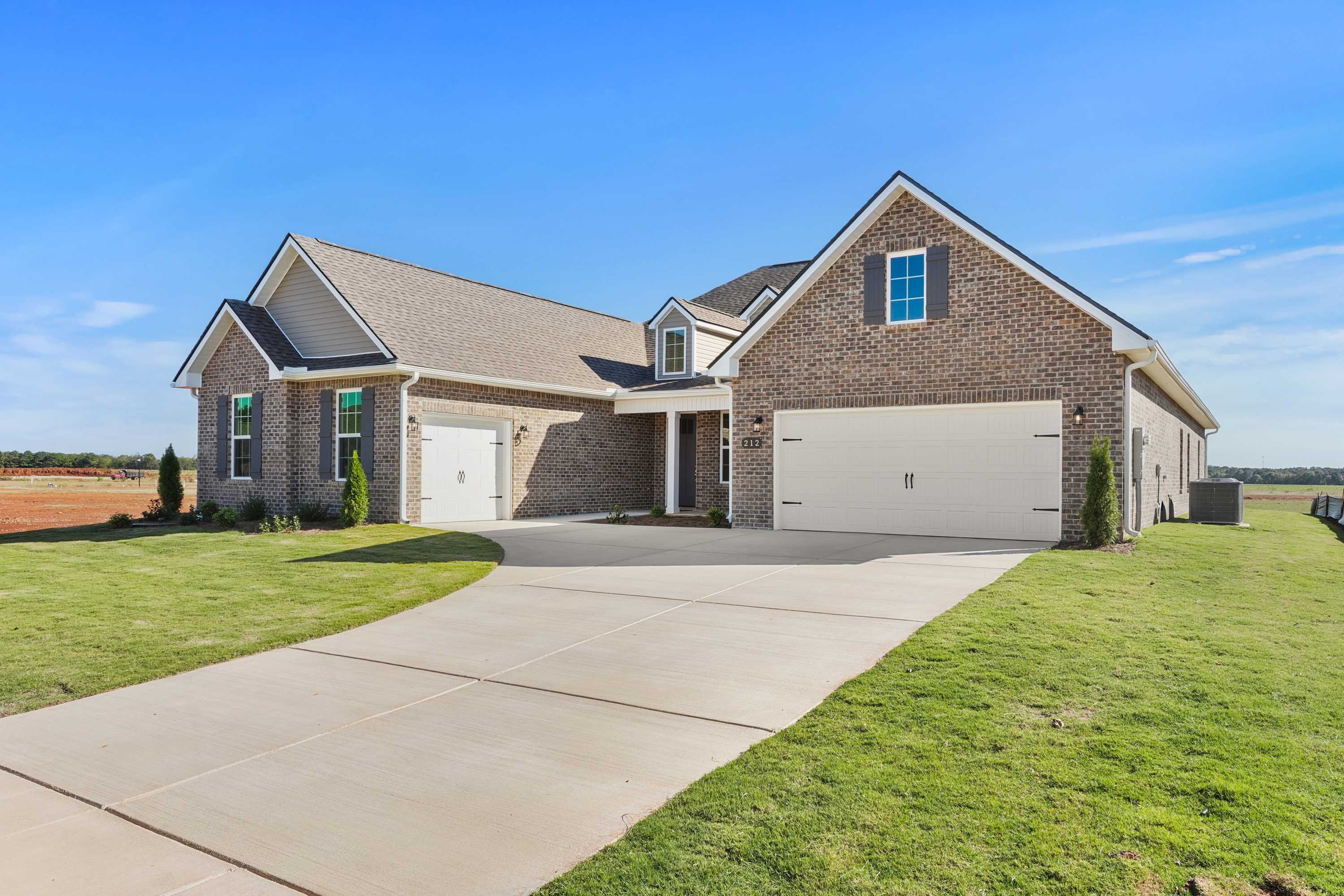The Valencia single-story home exterior with brick siding, 3-car garage, covered entry, and driveway in Meridianville Alabama