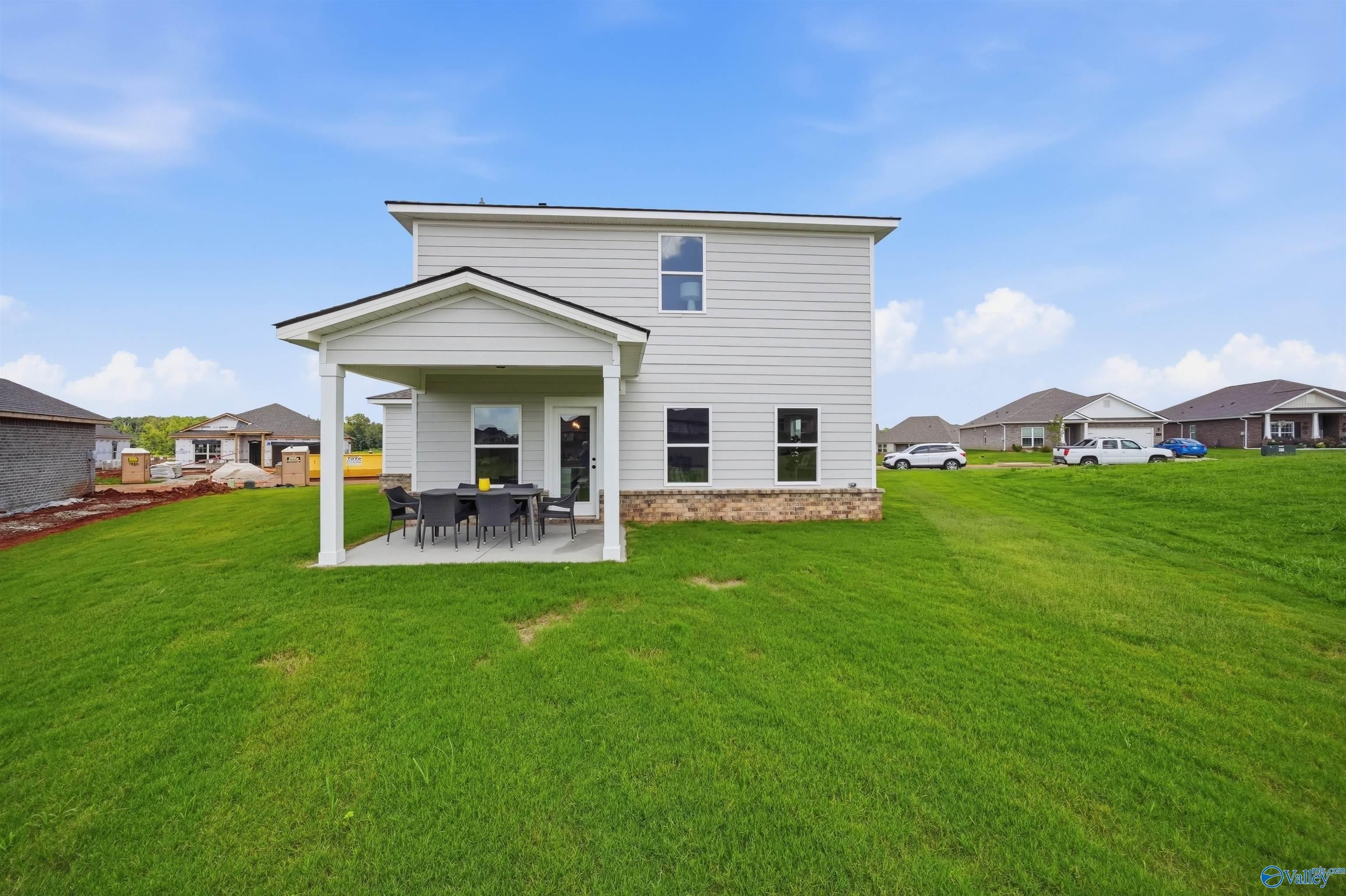 Covered back patio and large backyard of The Burton B floor plan by Davidson Homes in Heritage Lakes, New Market, Alabama.