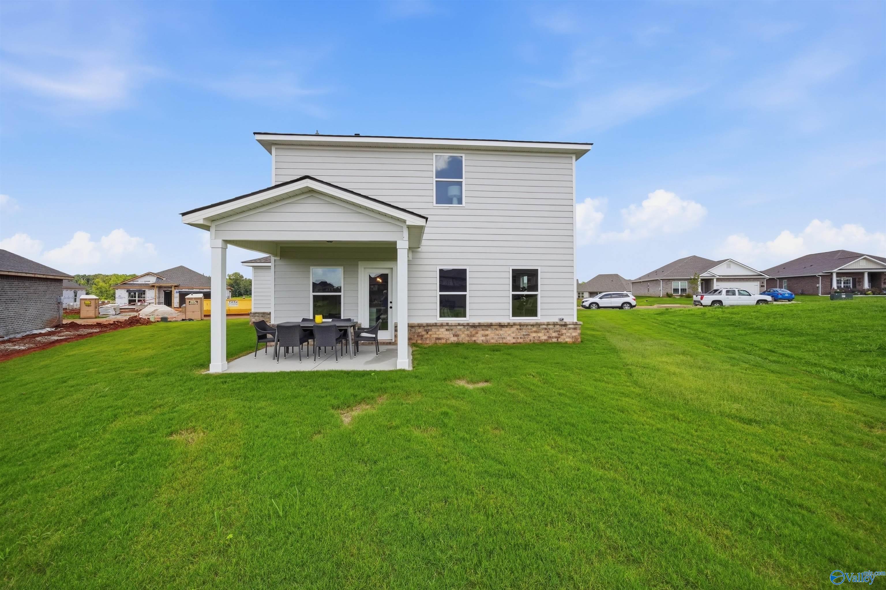 Covered back patio and large backyard of The Burton B floor plan by Davidson Homes in Heritage Lakes, New Market, Alabama.