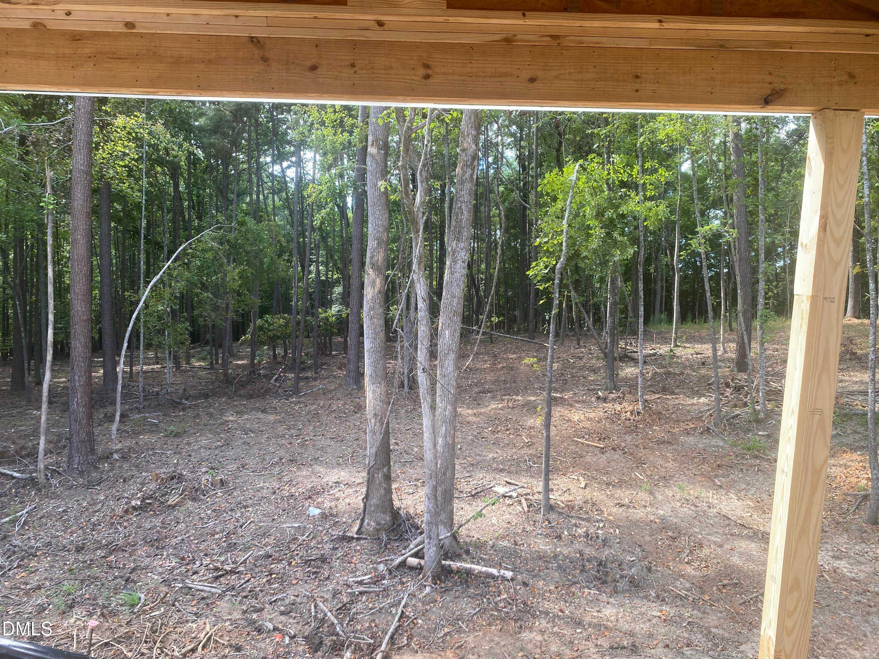 Covered wooden patio overlooking dense private forest backyard in Davidson Homes The Beech B, Laneridge Estates, Raleigh, NC