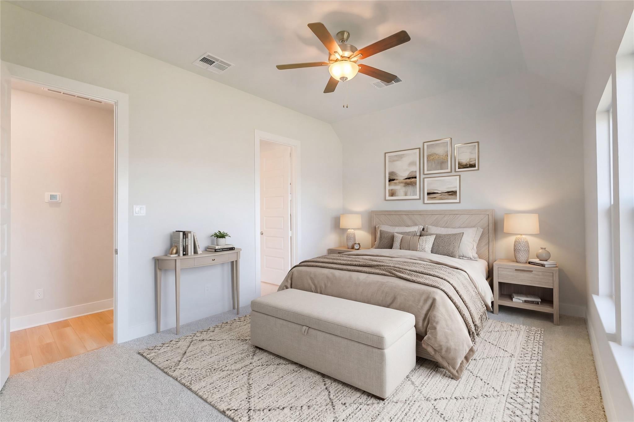 Serene master bedroom with king bed, beige linens, ceiling fan, and neutral decor in Davidson Homes The Luna L, Katy, Texas