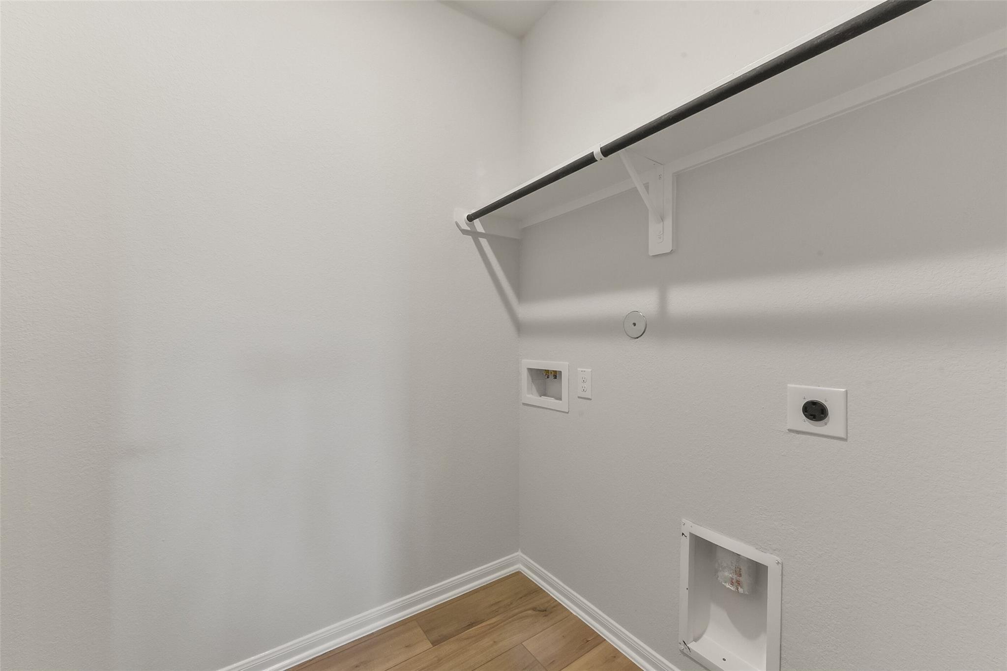 Spacious laundry room with closet rod, outlets, and dryer vent in Davidson Homes The Laguna B, Magnolia, Texas