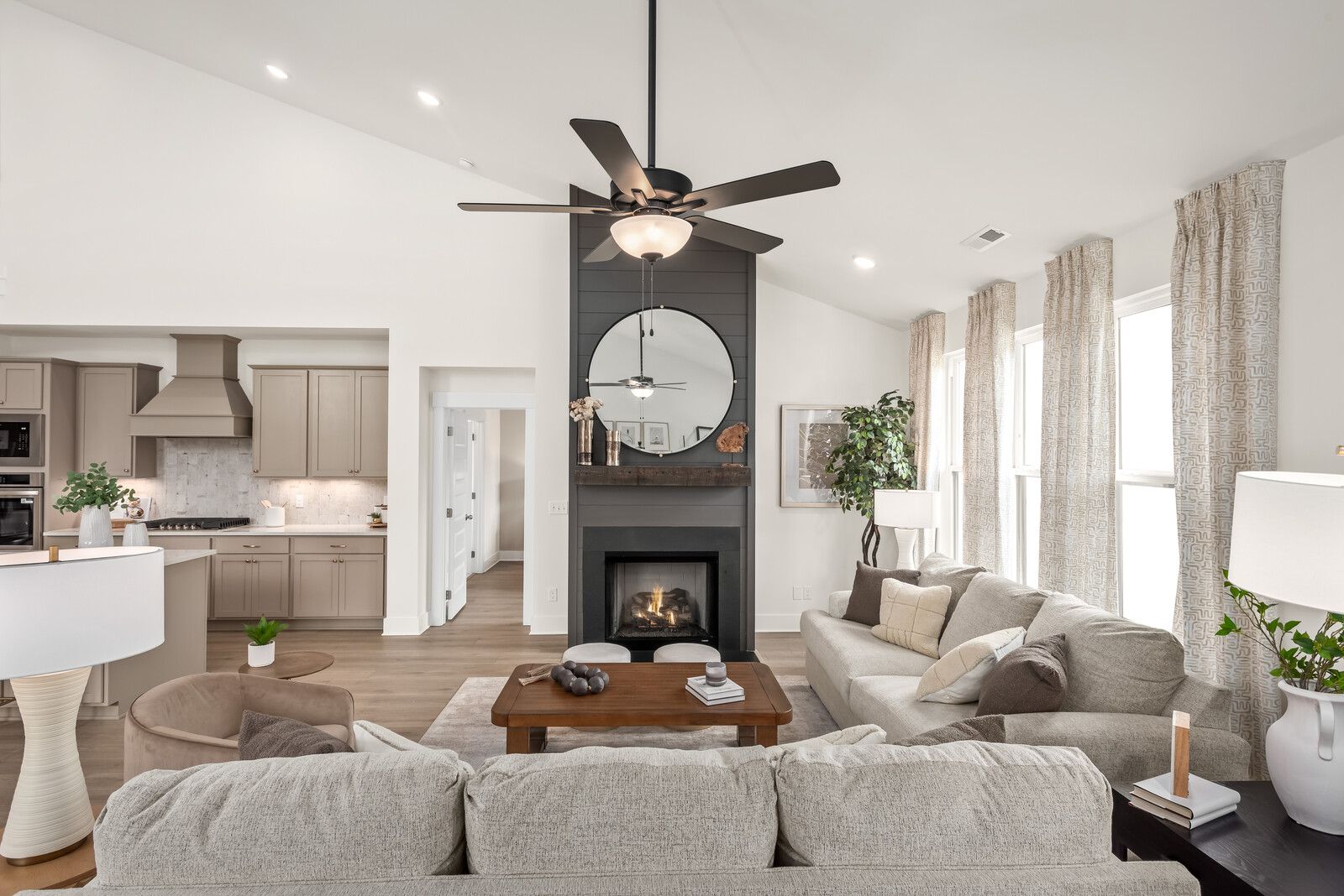Open-concept living room at Benders Cove in Mt. Juliet, TN with a fireplace, vaulted ceilings, and Davidson Homes design.