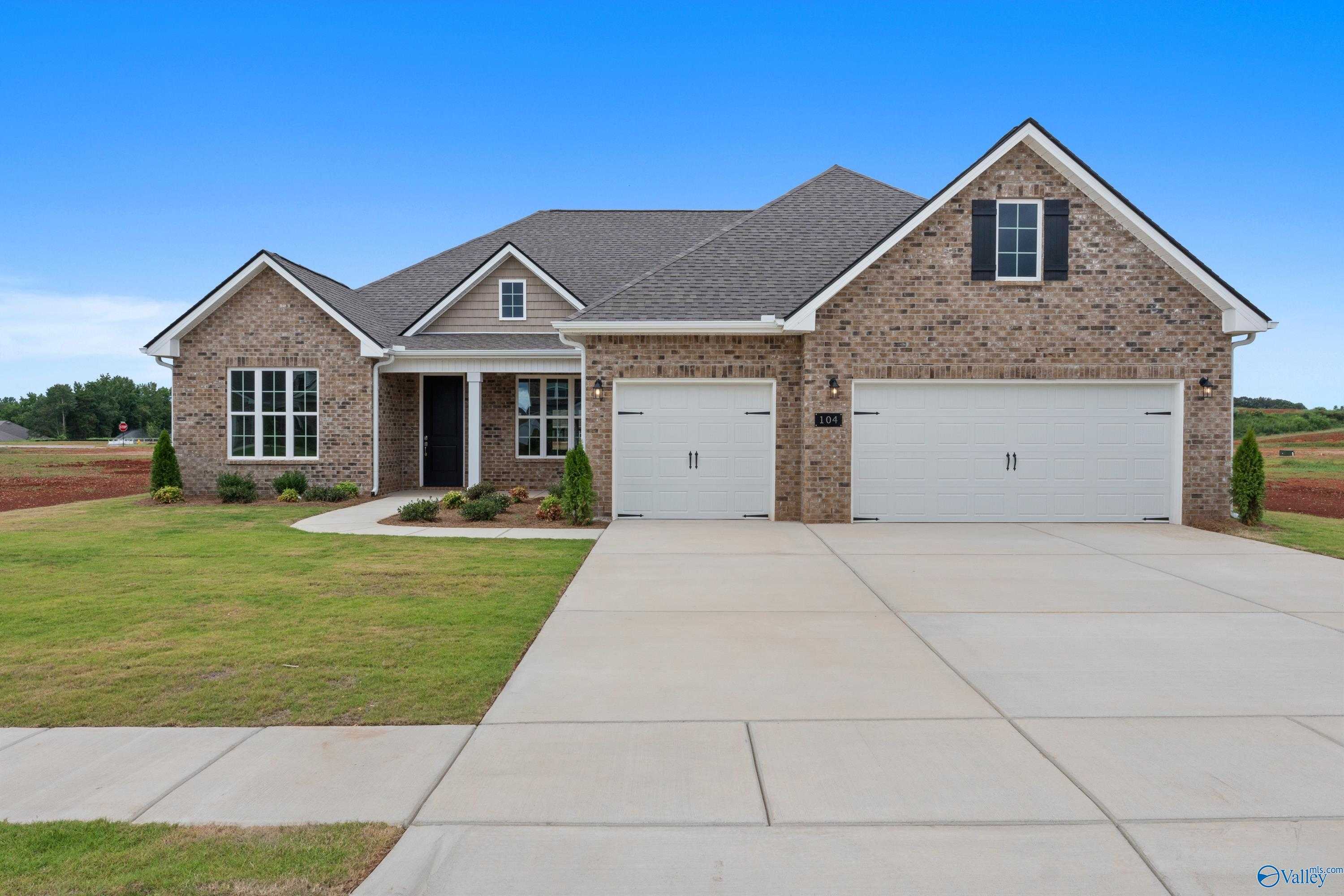 Brick single-story Finleigh home with gabled roof, 2-car garage, and landscaped front yard in Briercreek, Meridianville, Alabama